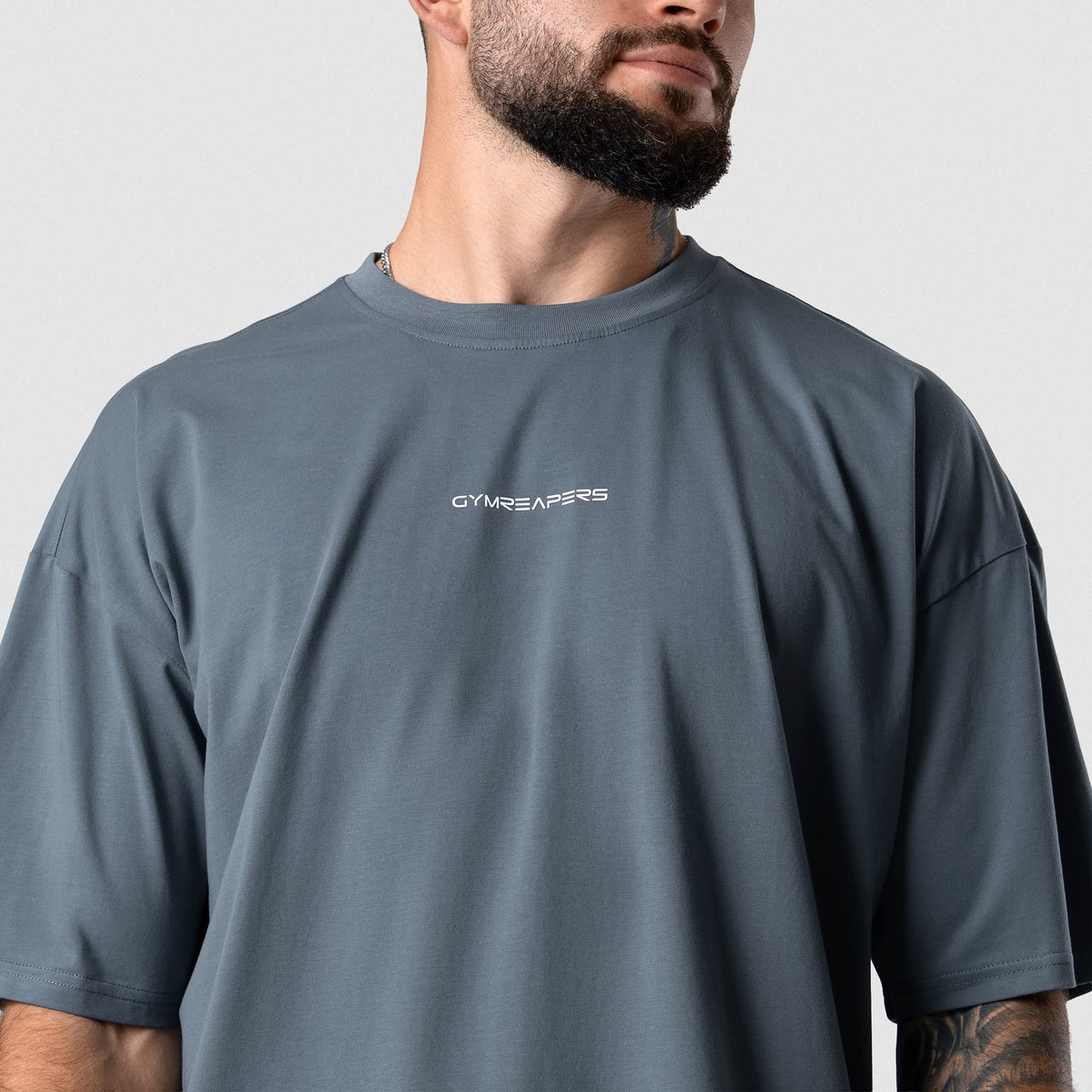 Male model wearing the Axis Box Tee - Lake angled chest view