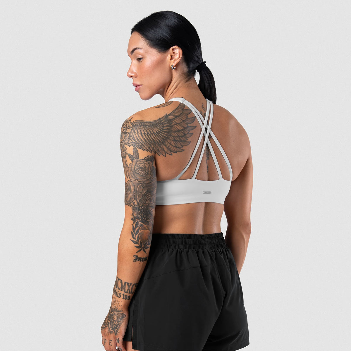 Female model wearing the Axis High Neck Bra - White back view