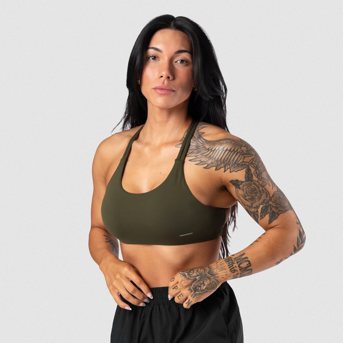 Female model wearing the Axis Open Back Bra - OD Green front view