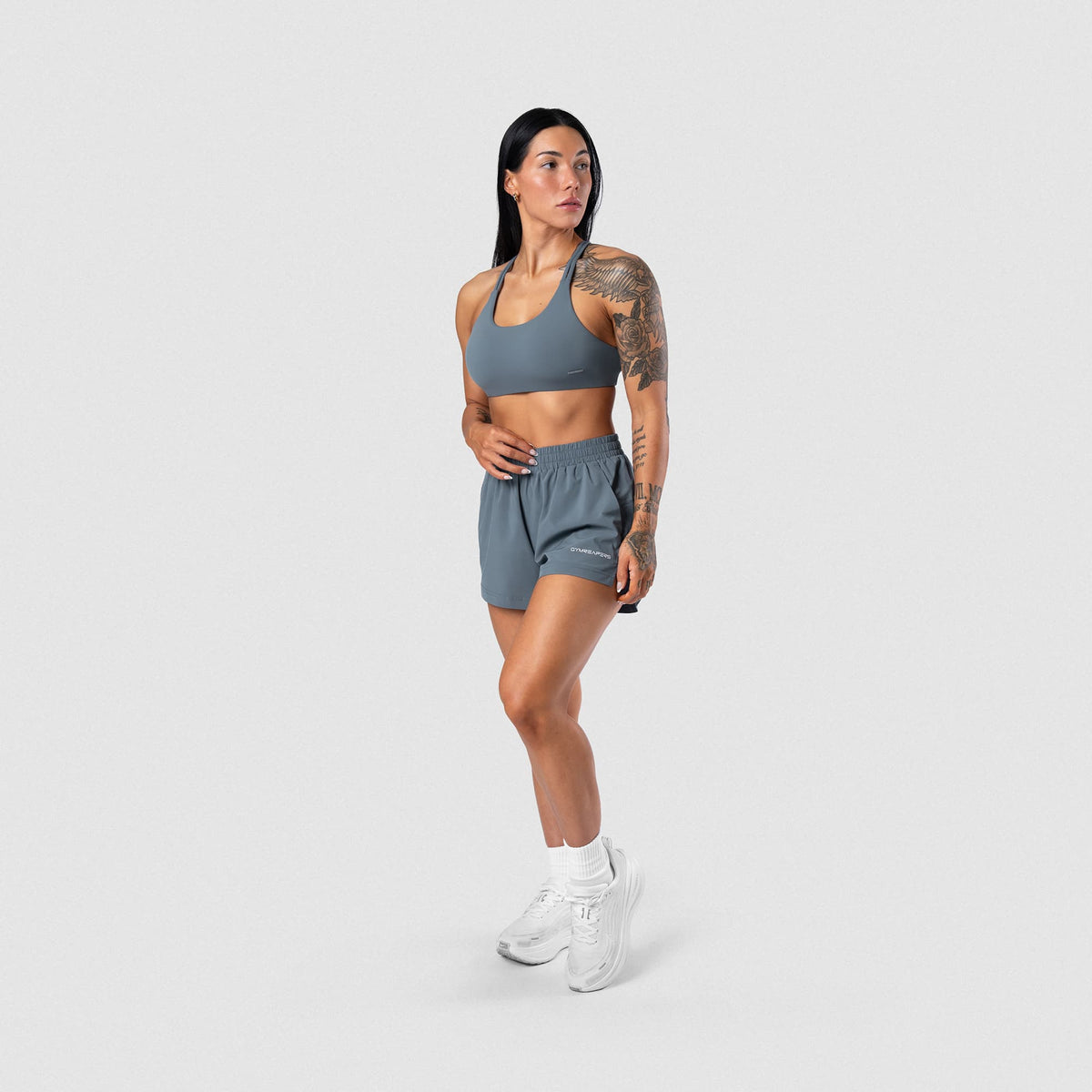 Female model wearing the Axis Open Back Bra - Lake full-body view