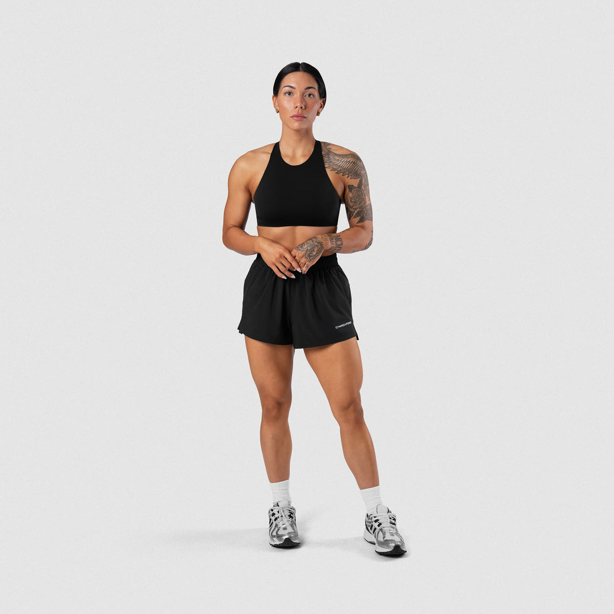 Female model wearing the Axis Sport Shorts - Black full-body front view