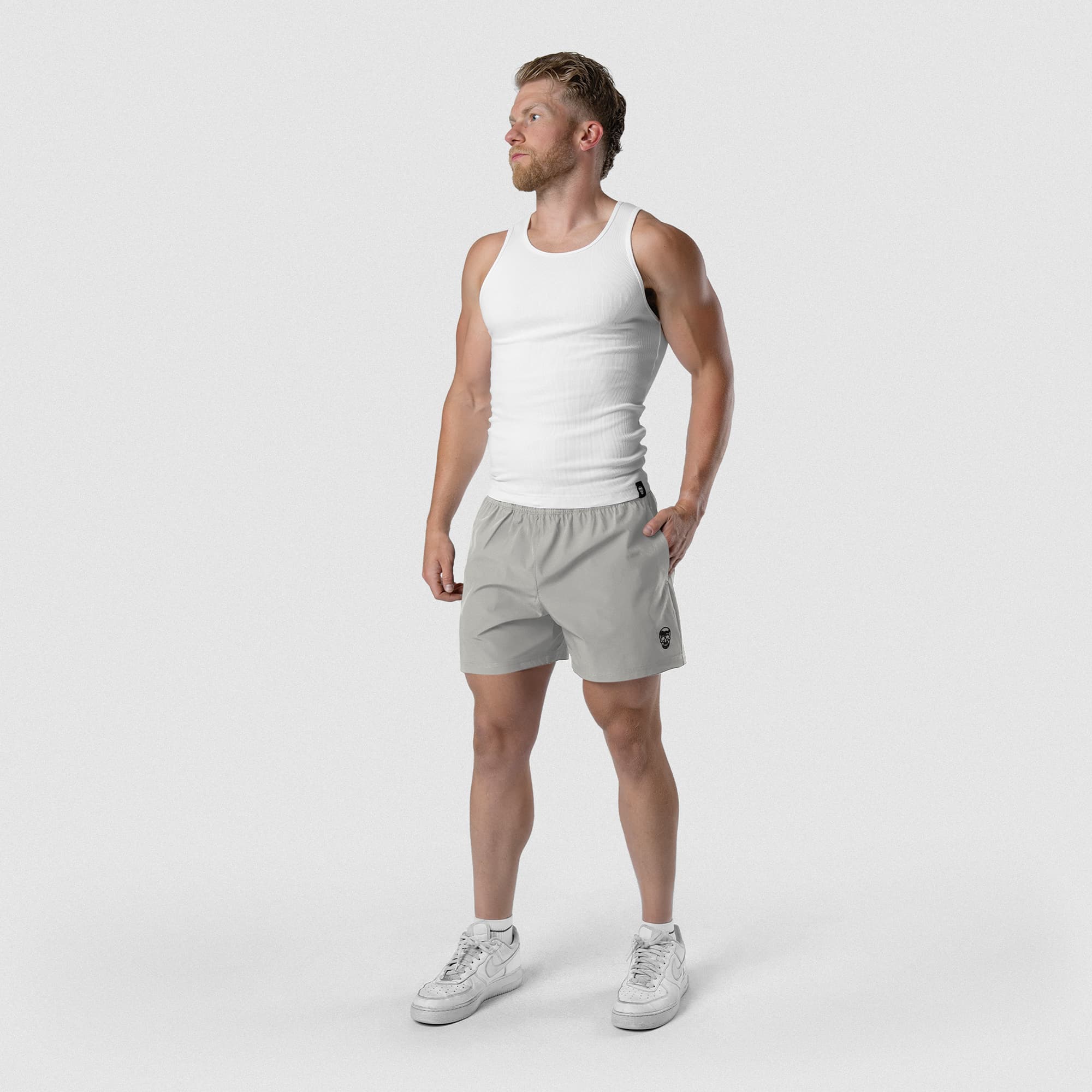 Model wearing Men's Conquer 5 Inch Shorts - Gray