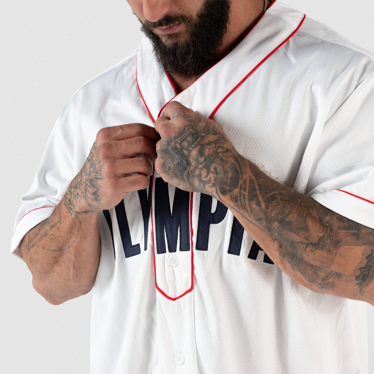 Olympia Americana Jersey | Male model adjusting the buttons of the jersey and buttoning the top button