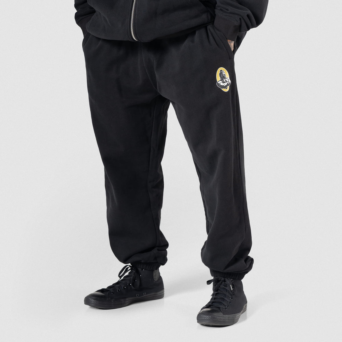 Front of black Olympia Champions Gold Jogger sweatpants on male model