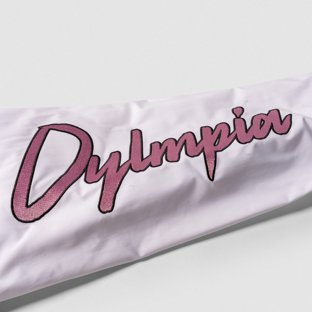 Rose Division Crop Bomber Jacket | White Sleeve detailing with the Pink "Olympia" wordmark text down the side
