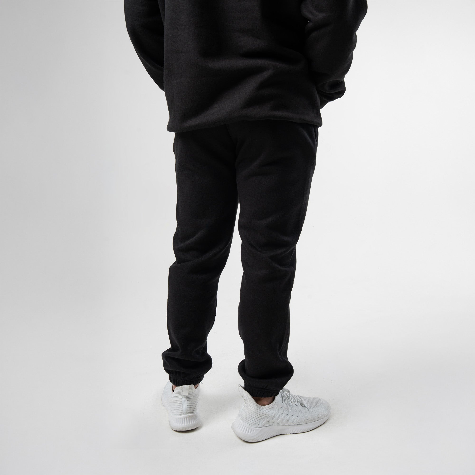 athlete wearing axis joggers half body shot back view