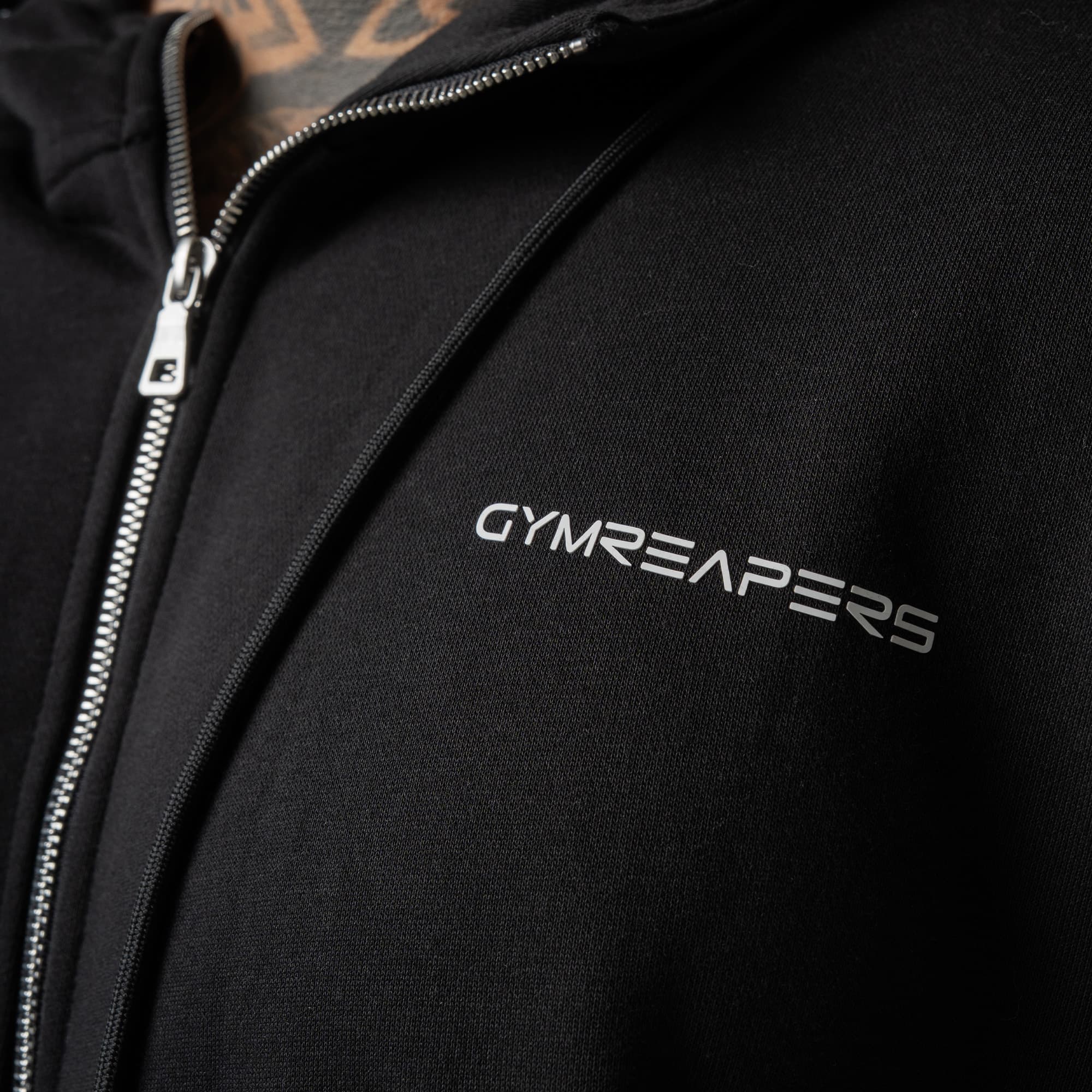 athlete wearing black/white axis zip up close up detail shot of logo
