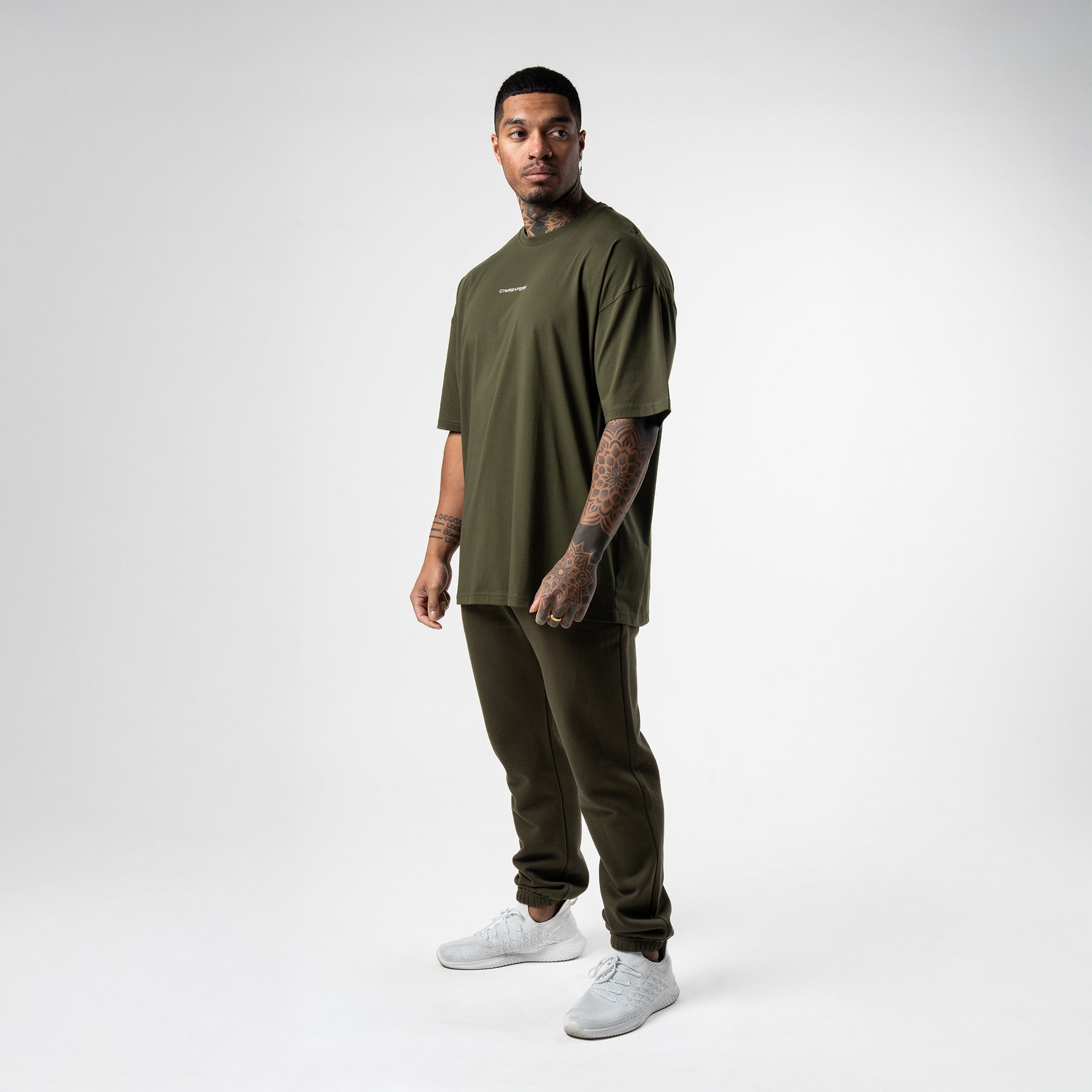 athlete wearing green axis box tee full body shot