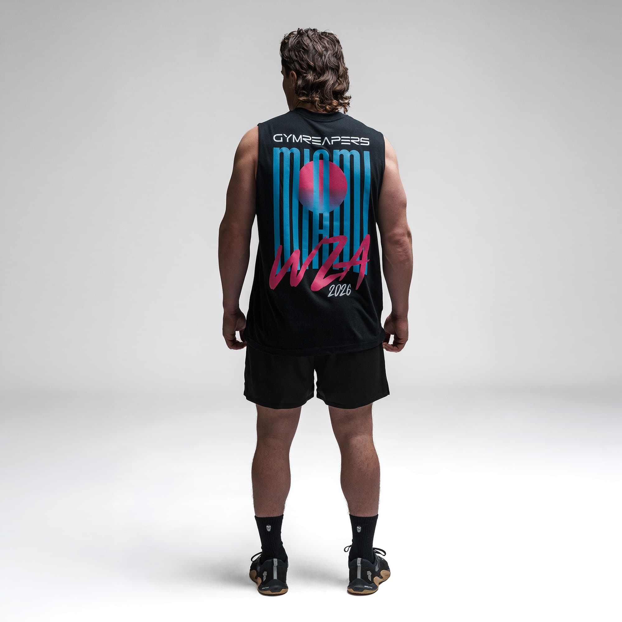 Athlete wearing the Neon Horizon Cut Off full body shot back side