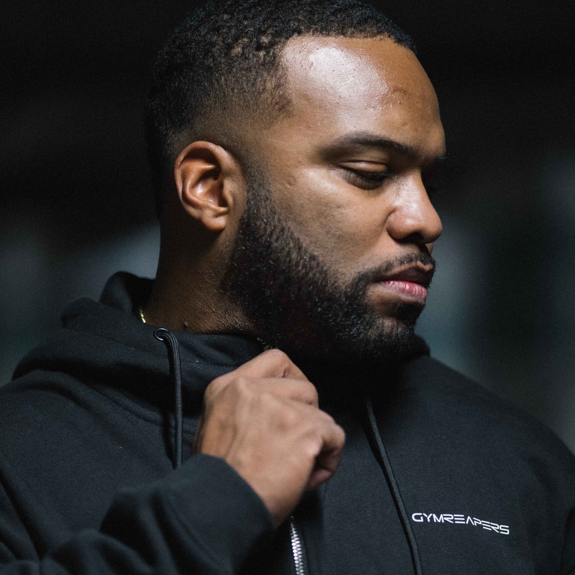 Axis zip up black white athlete holding front zipper close up
