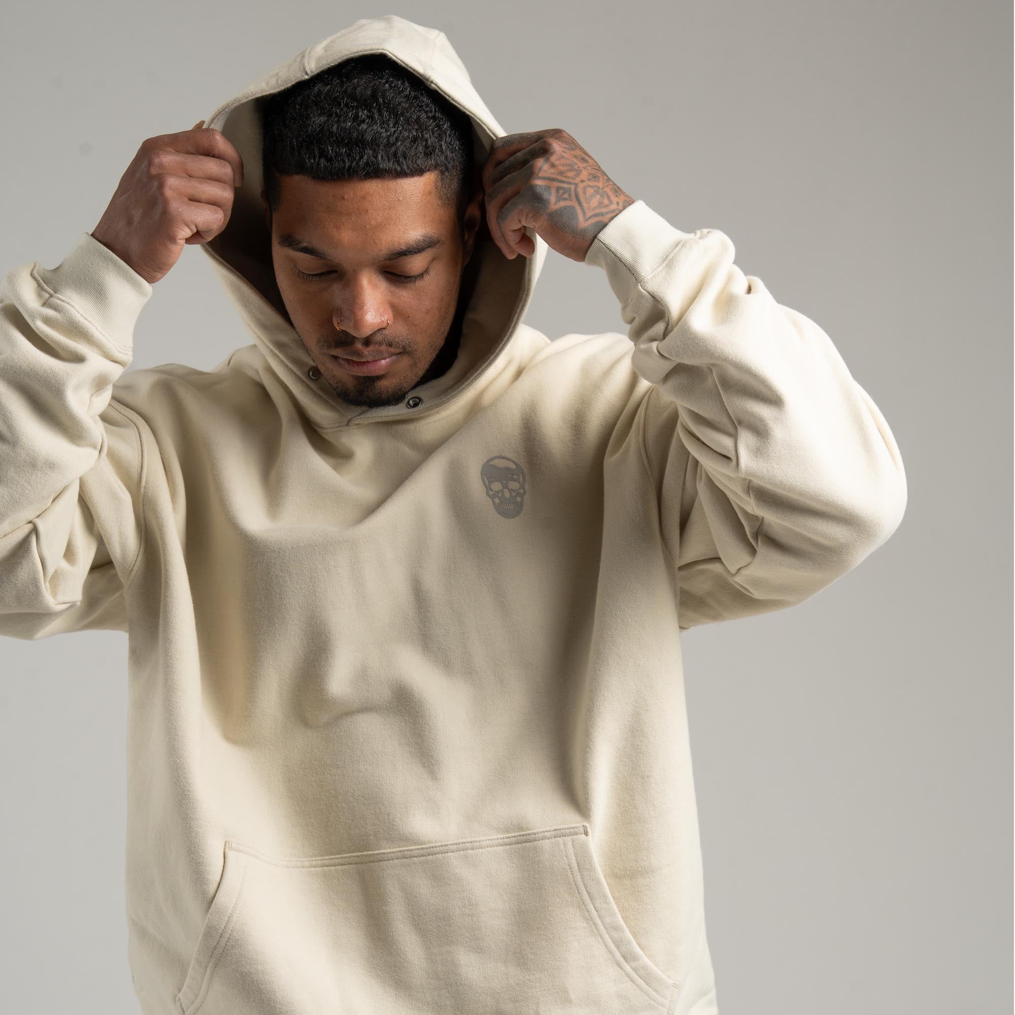 Athlete wearing Bone Heavyweight Hoodie with hood on