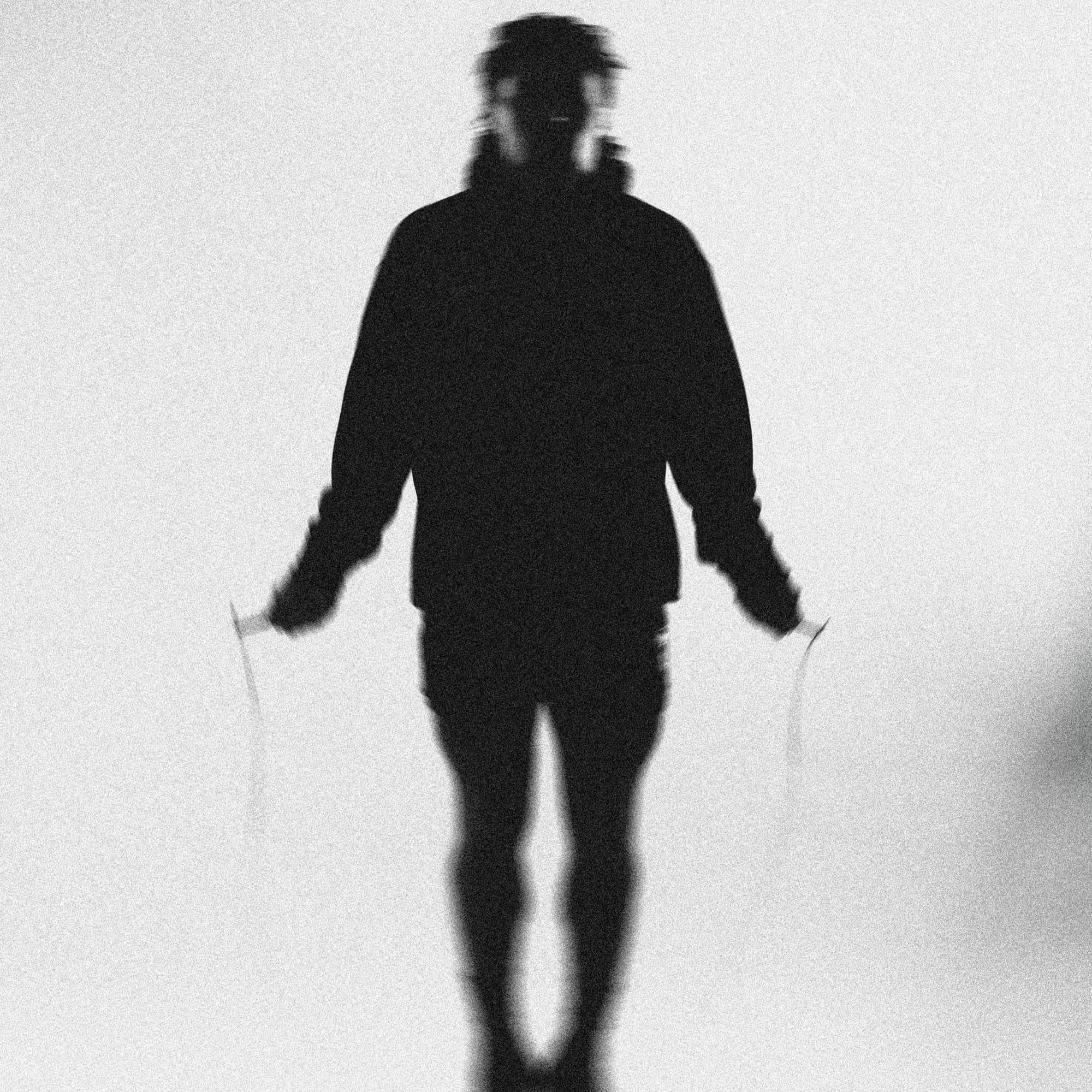 lifestyle shot of athlete wearing static ops hoodie jump roping
