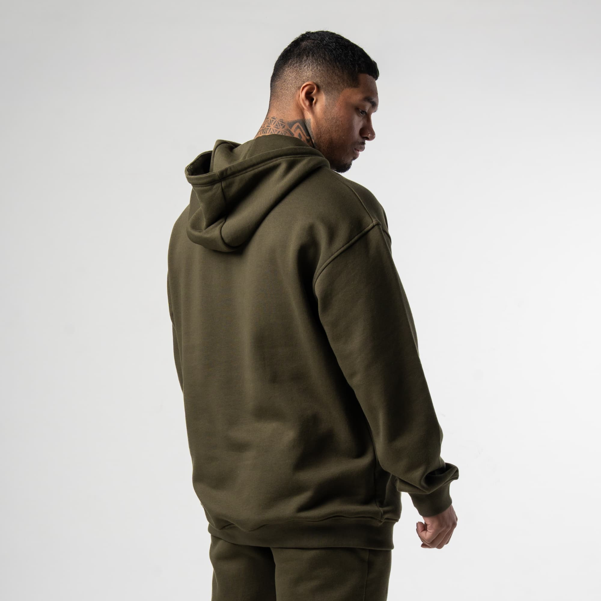 athlete wearing green axis mockneck hoodie back view