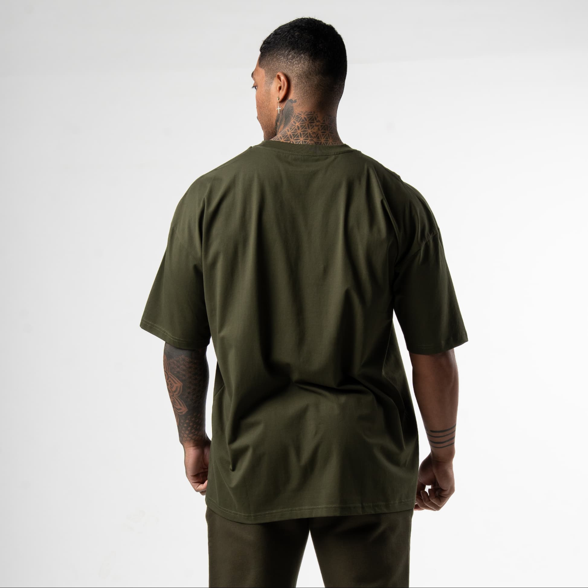 athlete wearing green axis box tee back view