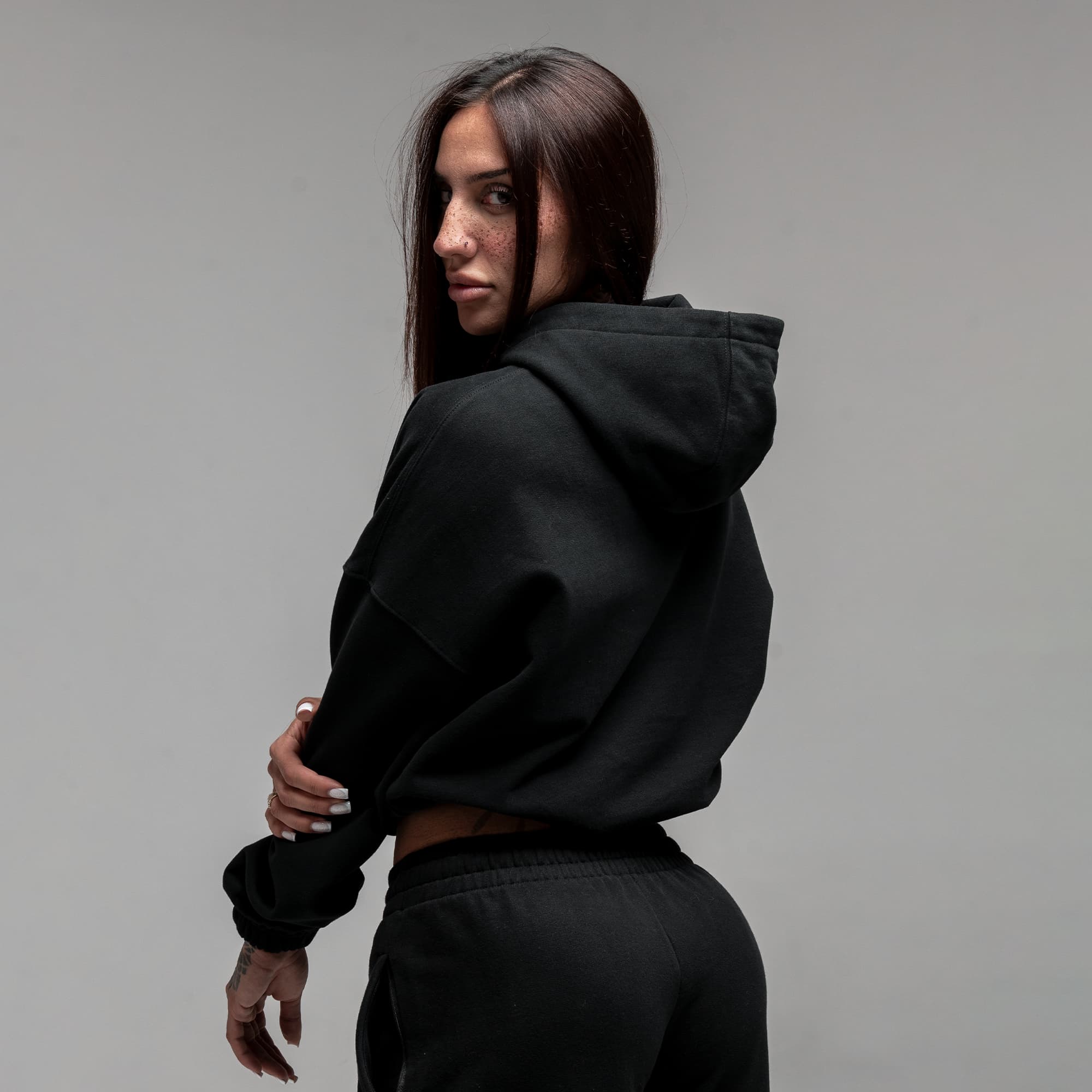 Athlete wearing Loyalty Club Cropped Hoodie half body shot back view