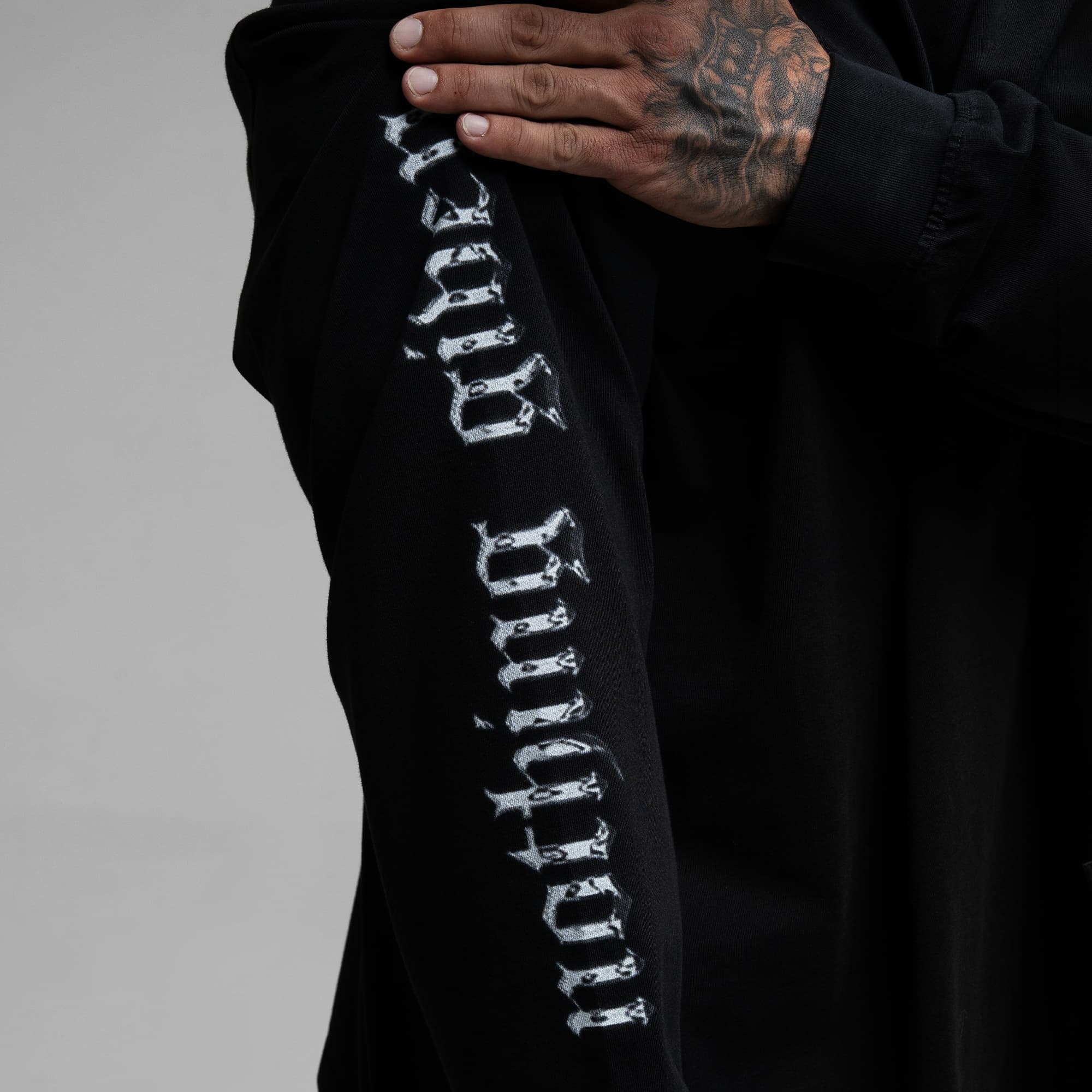 Athlete wearing Chrome Legacy Long Sleeve Shirt close up shot of "nothing given" sleeve graphic