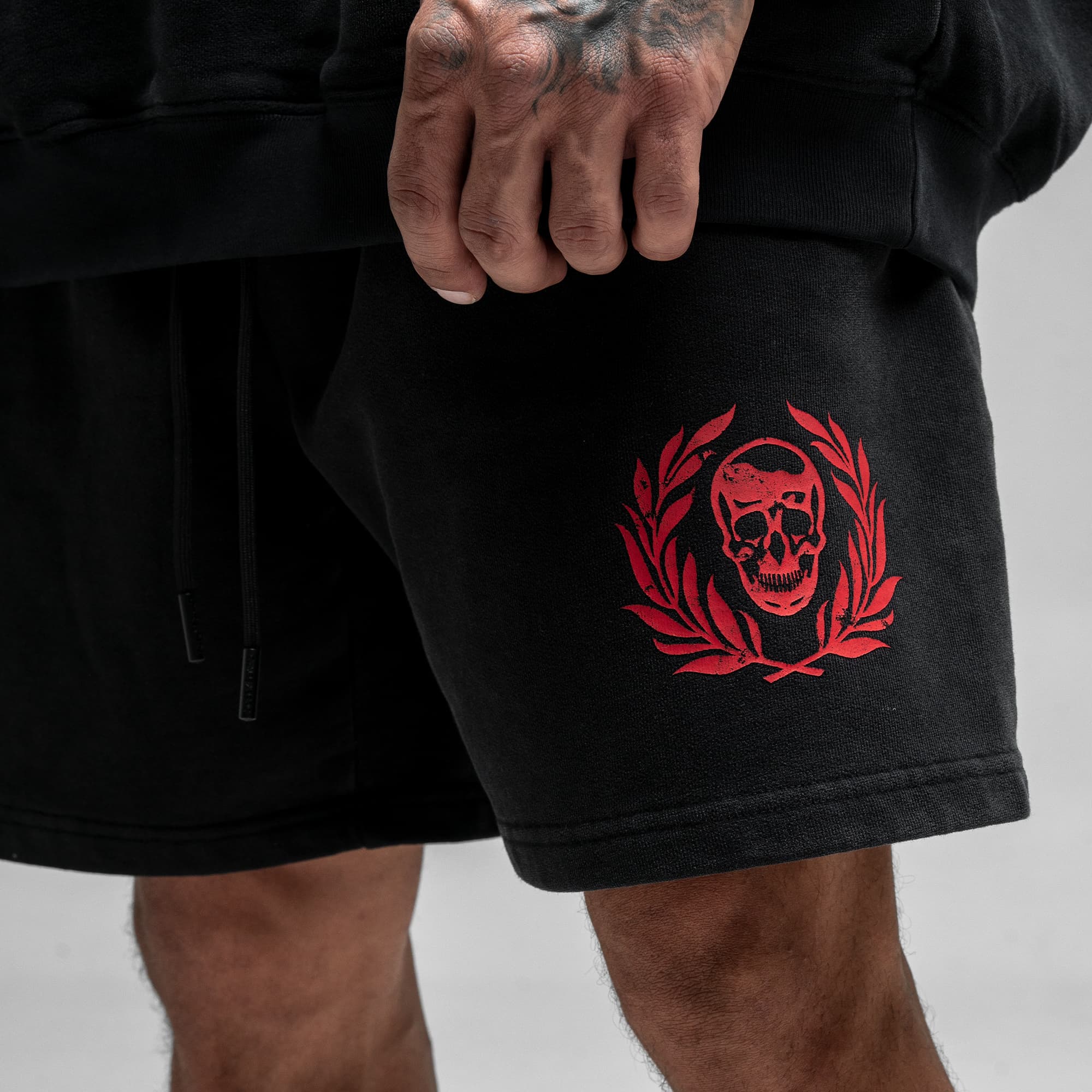 Athlete wearing the Loyalty Sweat Shorts close up shot of skull logo