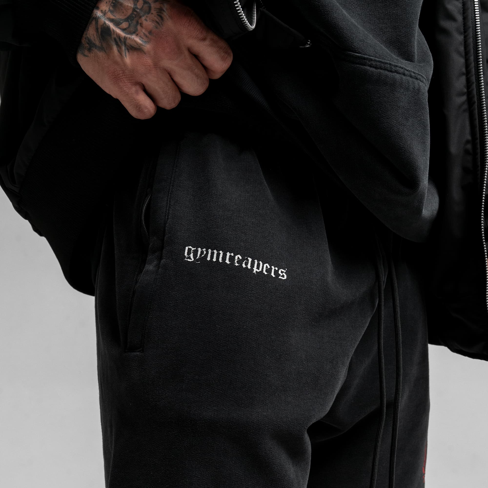 Athlete wearing the Loyalty Sweat Shorts close up shot of gymreapers logo