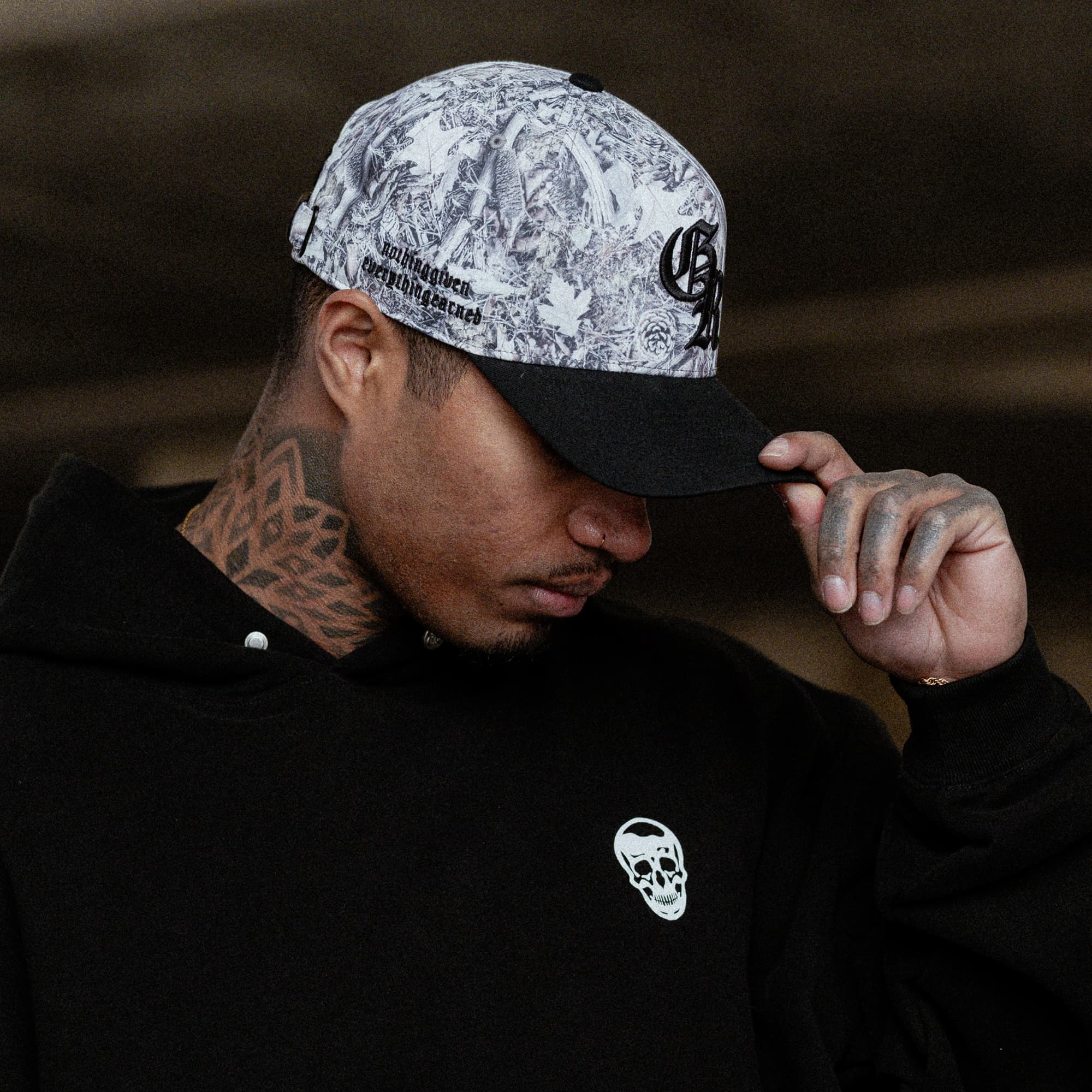 lifestyle shot of athlete wearing the Camo Initial Trucker Hat side view