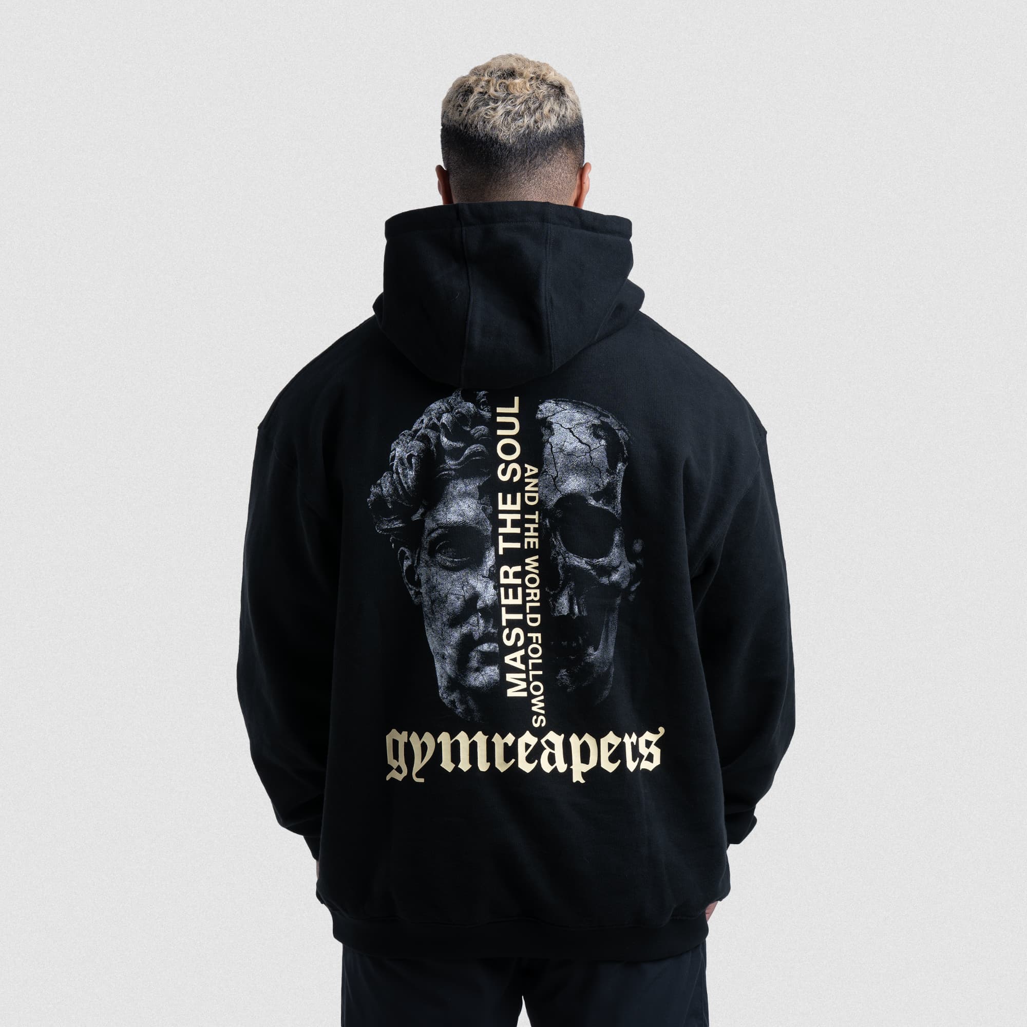 Back of black Master The Soul Hoodie with skull and statue graphic and Gymreapers logo.