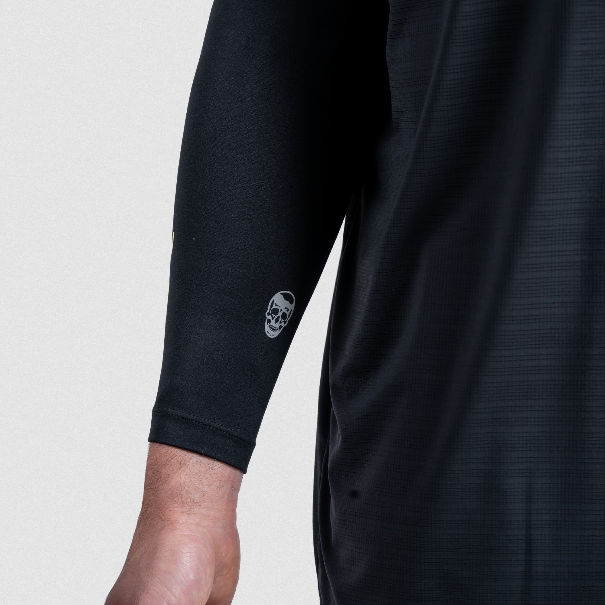 Close-up of Gymreapers skull logo on back side of arm warmer