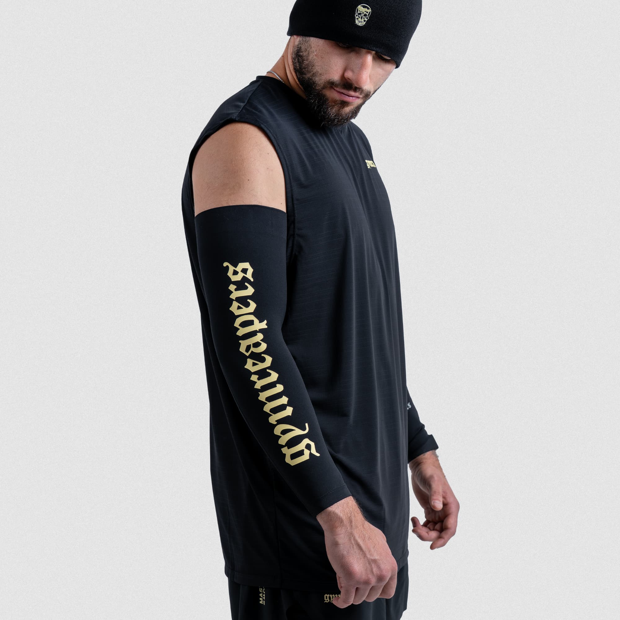 Athlete wearing Gymreapers Master the Soul arm warmer with gold Gymreapers text on black fabric