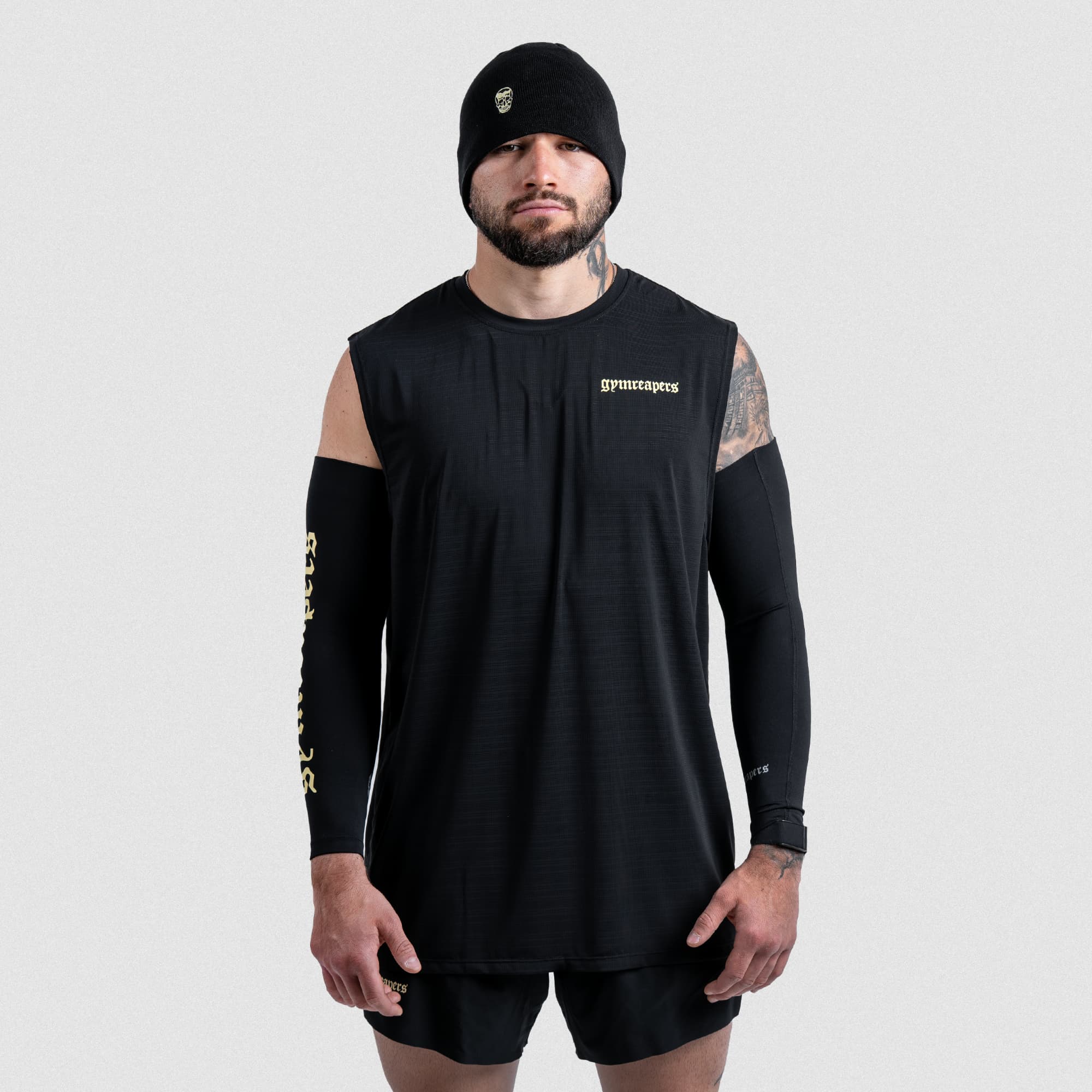 Athlete wearing full Gymreapers Master the Soul set with arm warmers and beanie, front shot