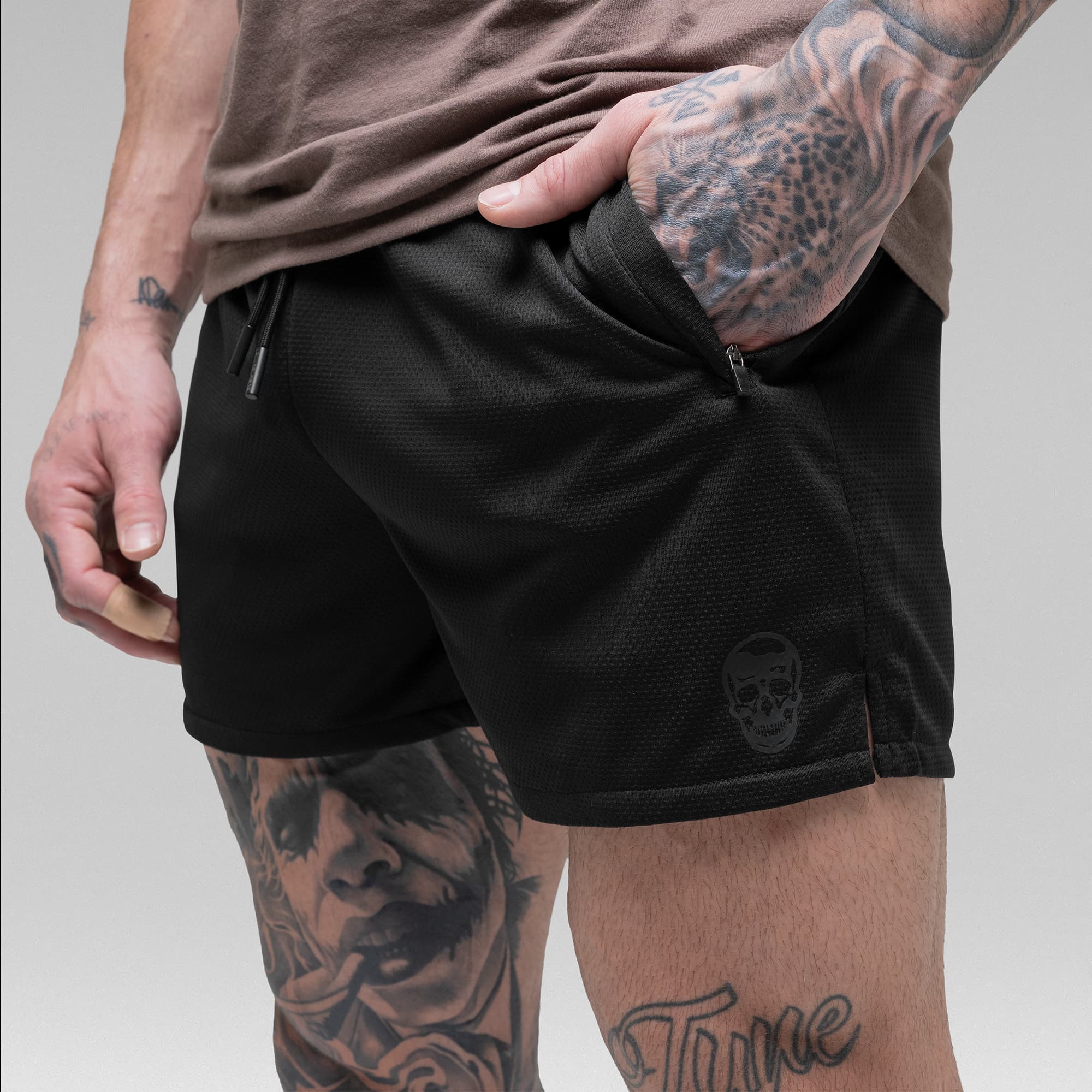 Athlete wearing the Black/Black Core Skull Mesh Training Shorts detail shot of pocket and logo