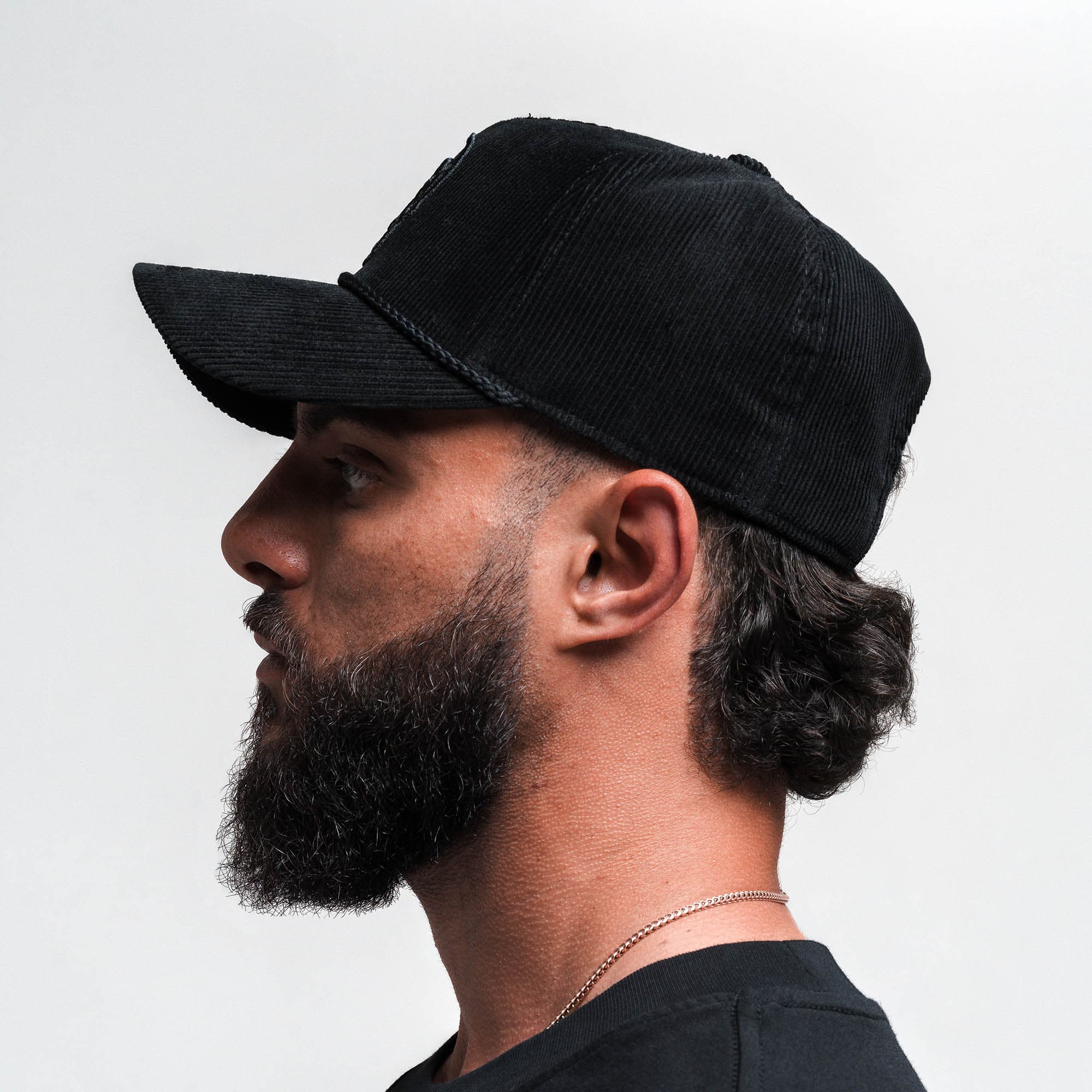 Athlete wearing Corduroy 5-Panel Skull Hat - Black/Black side view