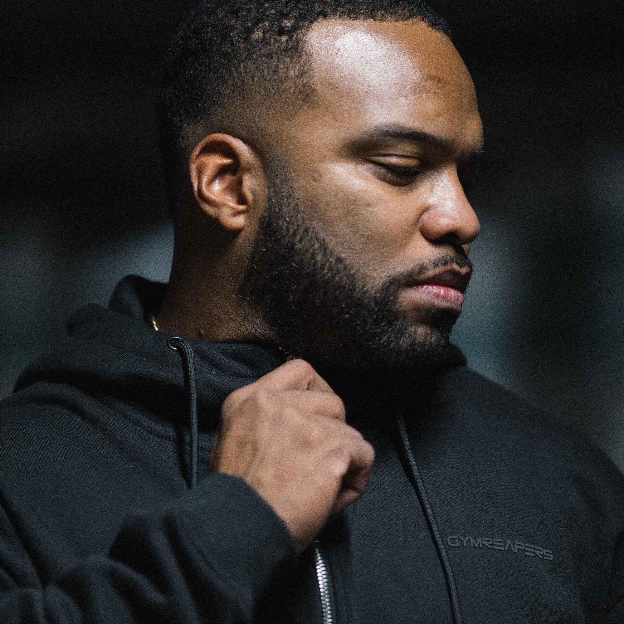 axis zip up black black athlete holding zipper close up