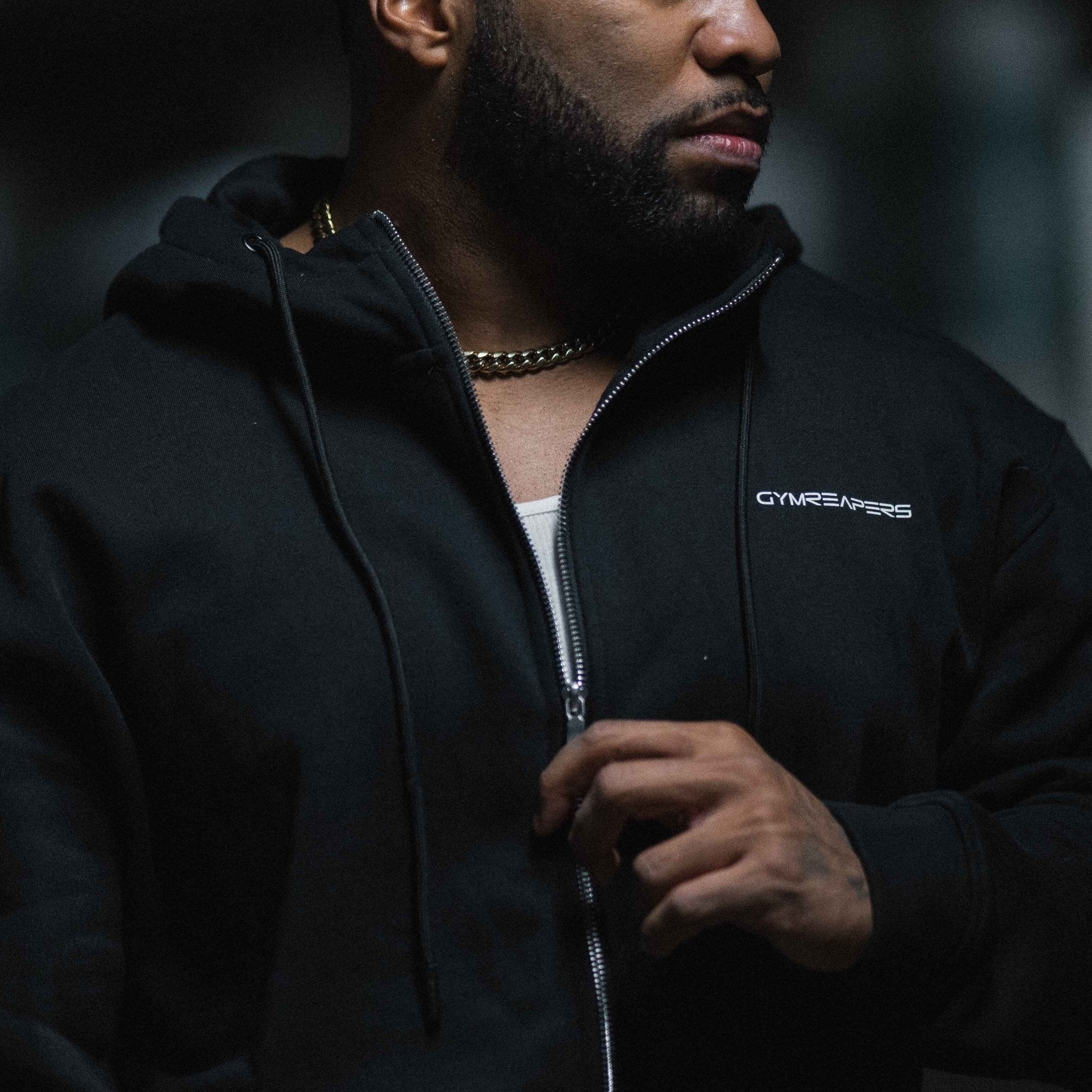 Axis zip up black white athlete unzipping hoodie close up.