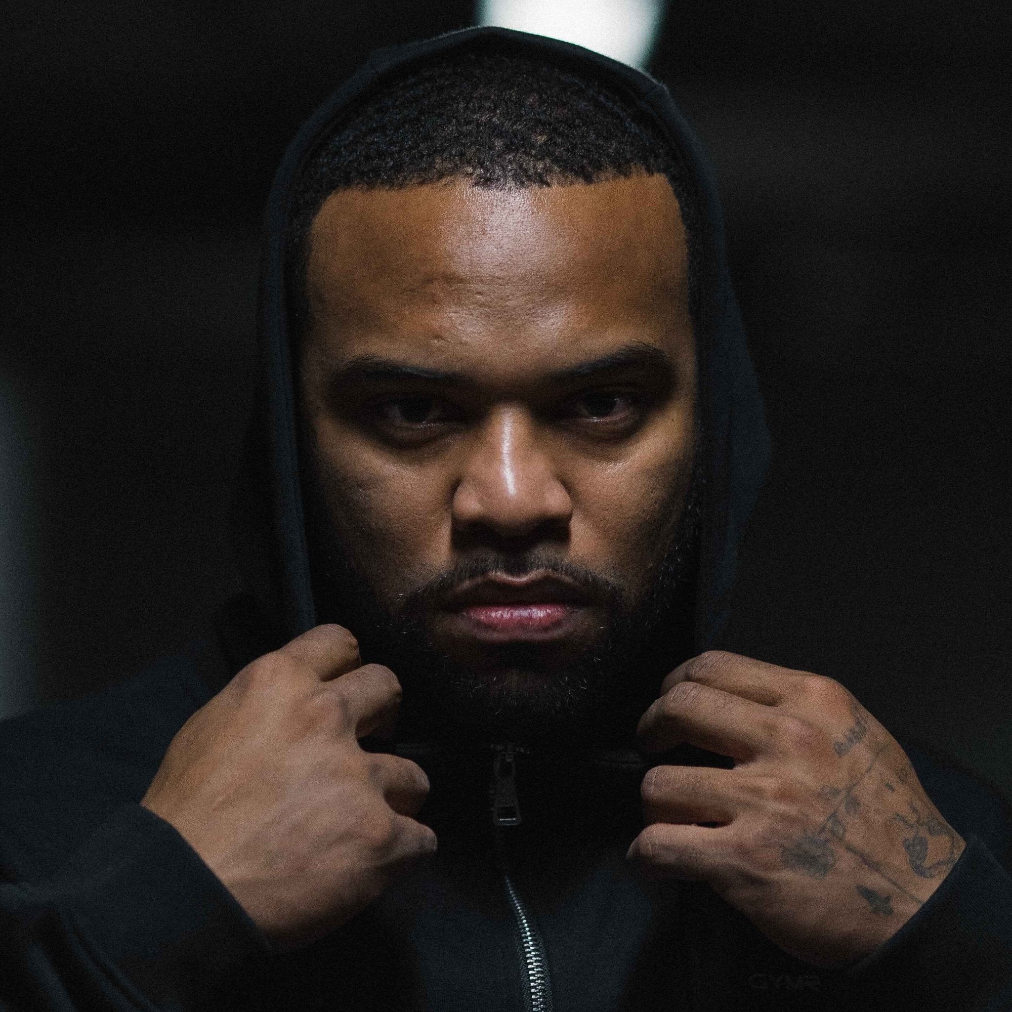axis zip up black black with athlete wearing hoodie over head.