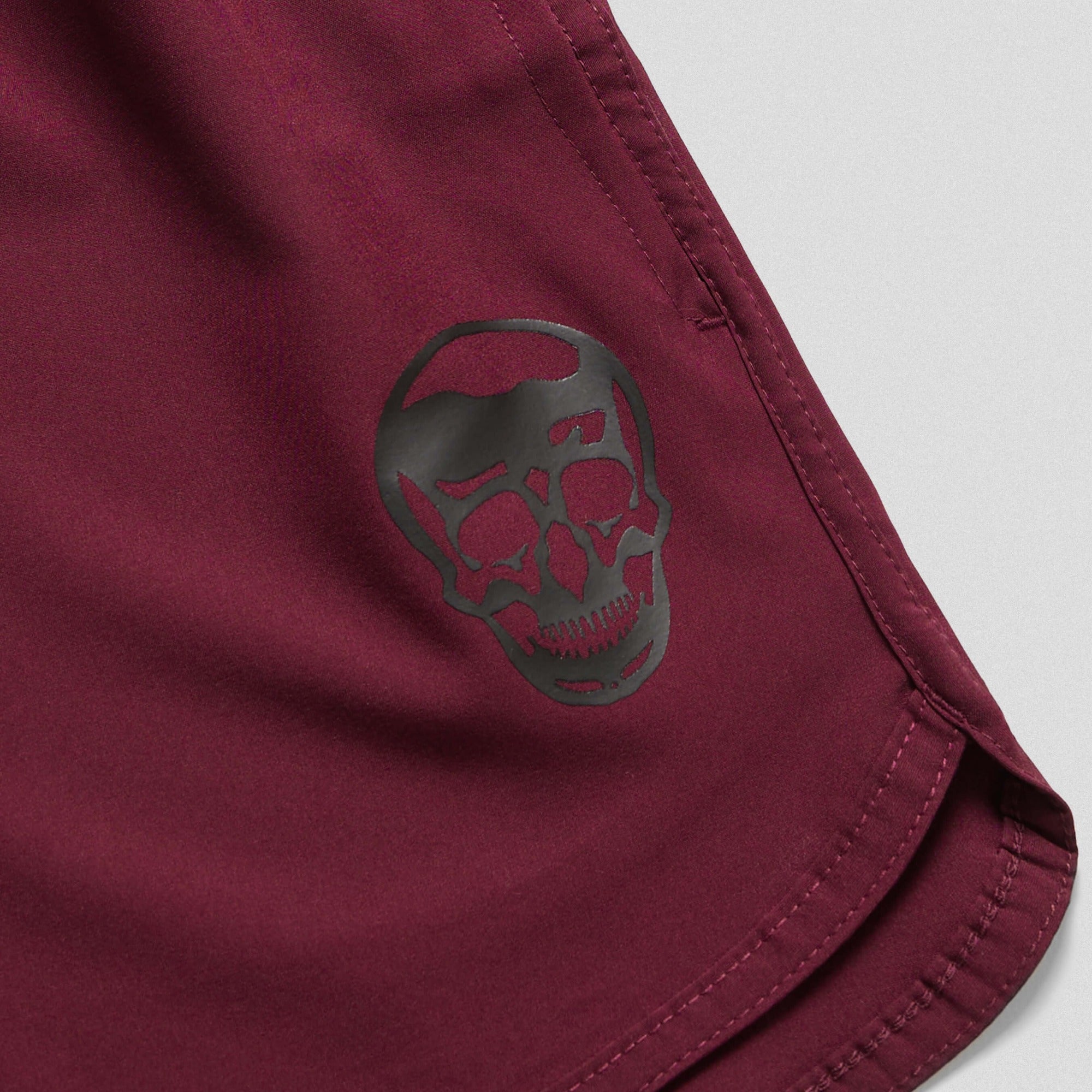 burgundy training shorts close up detail shot of logo