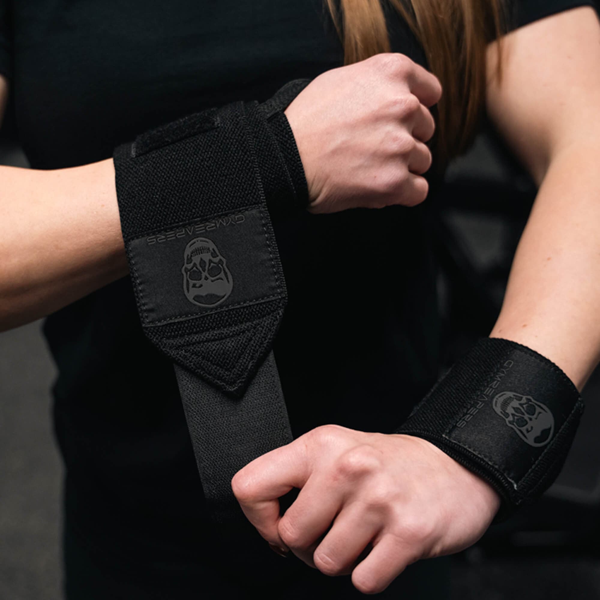 Athlete wearing black/black wrist wraps.
