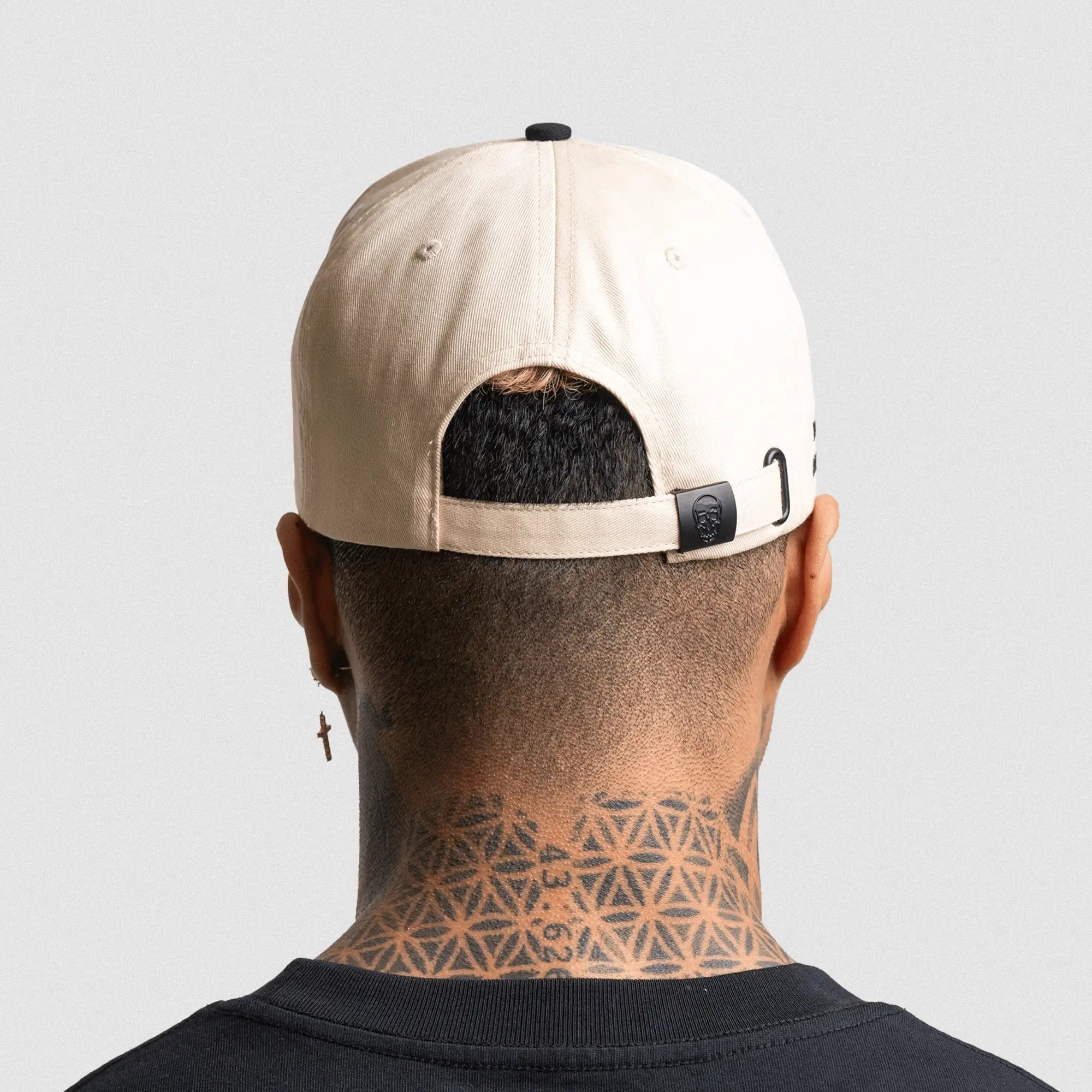 5 panel initial hat cream black on athlete studio gray background back shot