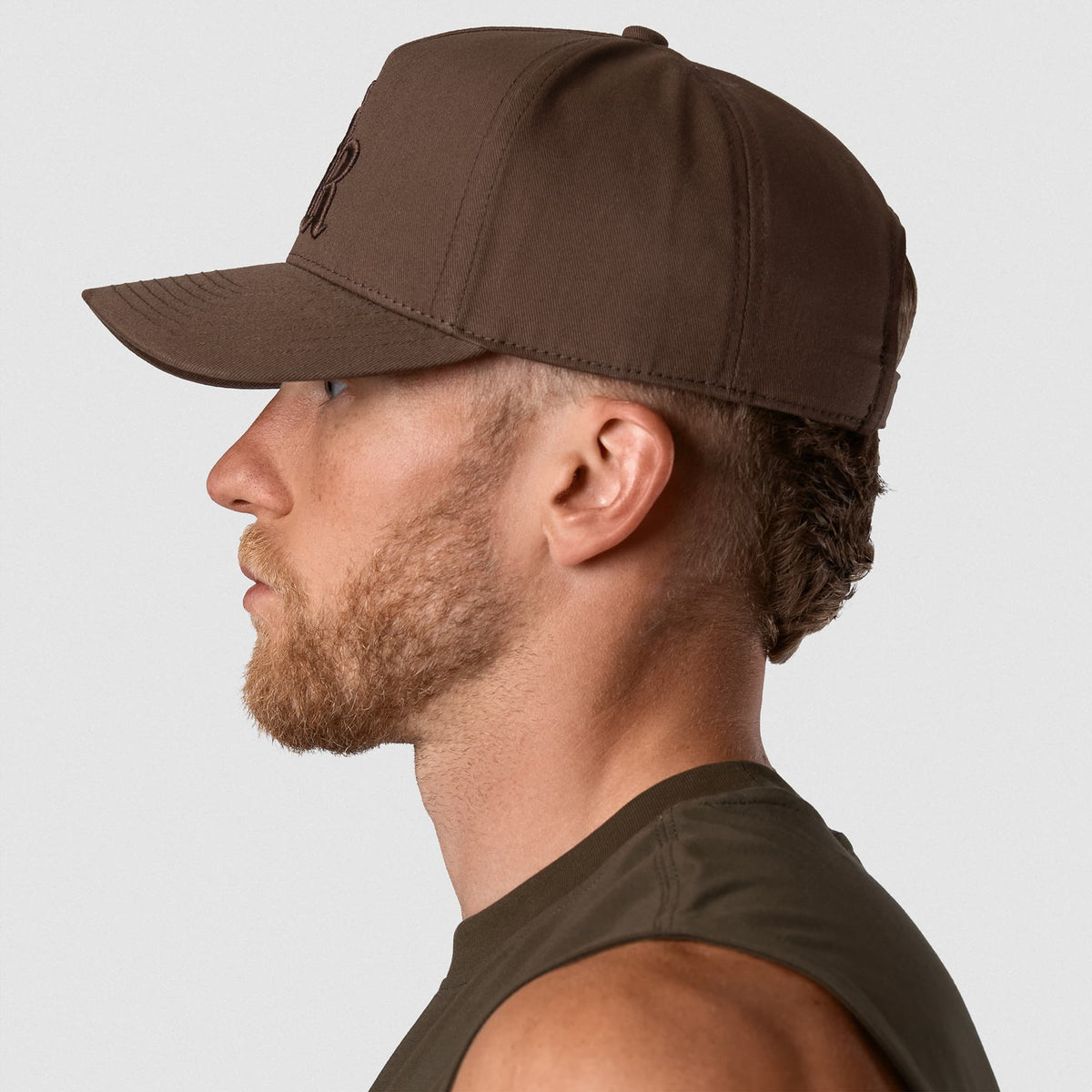 Male model wearing the 5-Panel Initial Hat - Brown left side view