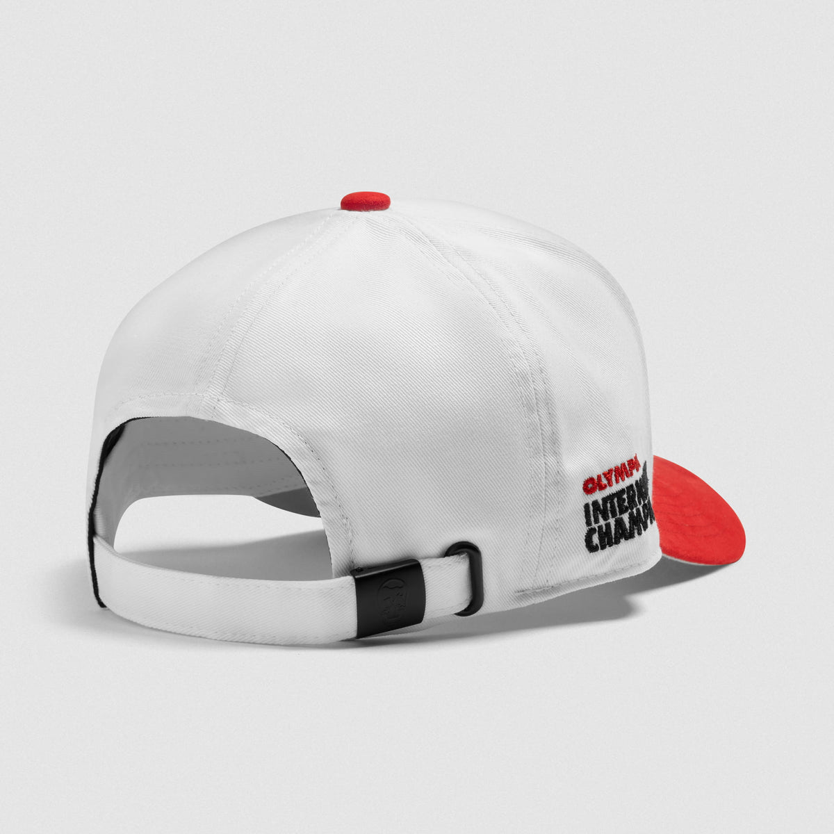 The back angled view of the International Division Suede 5-Panel Hat that displays the adjustable clasp and fit of the white hat