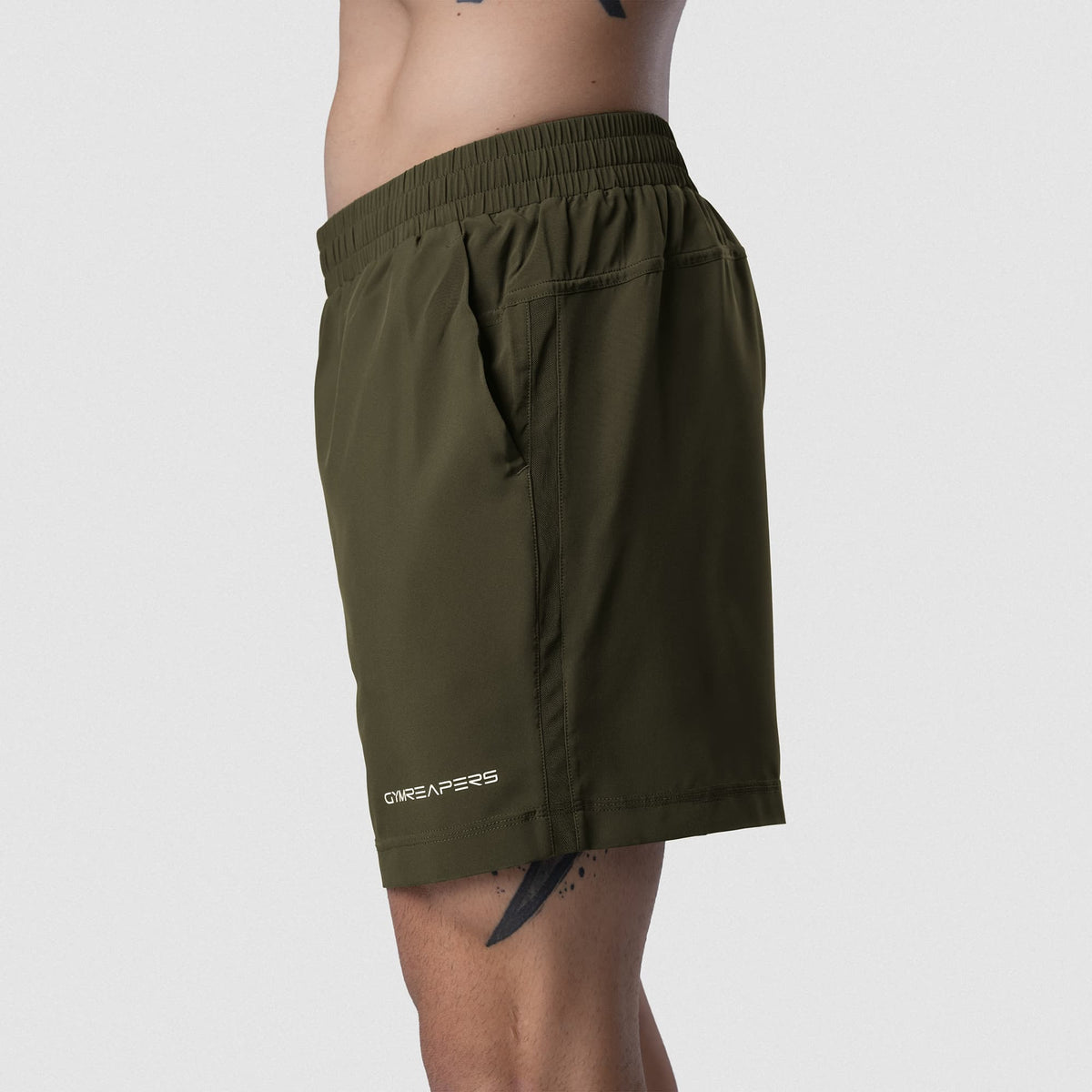 Male model wearing the Axis 6" Lined Shorts - OD Green side view