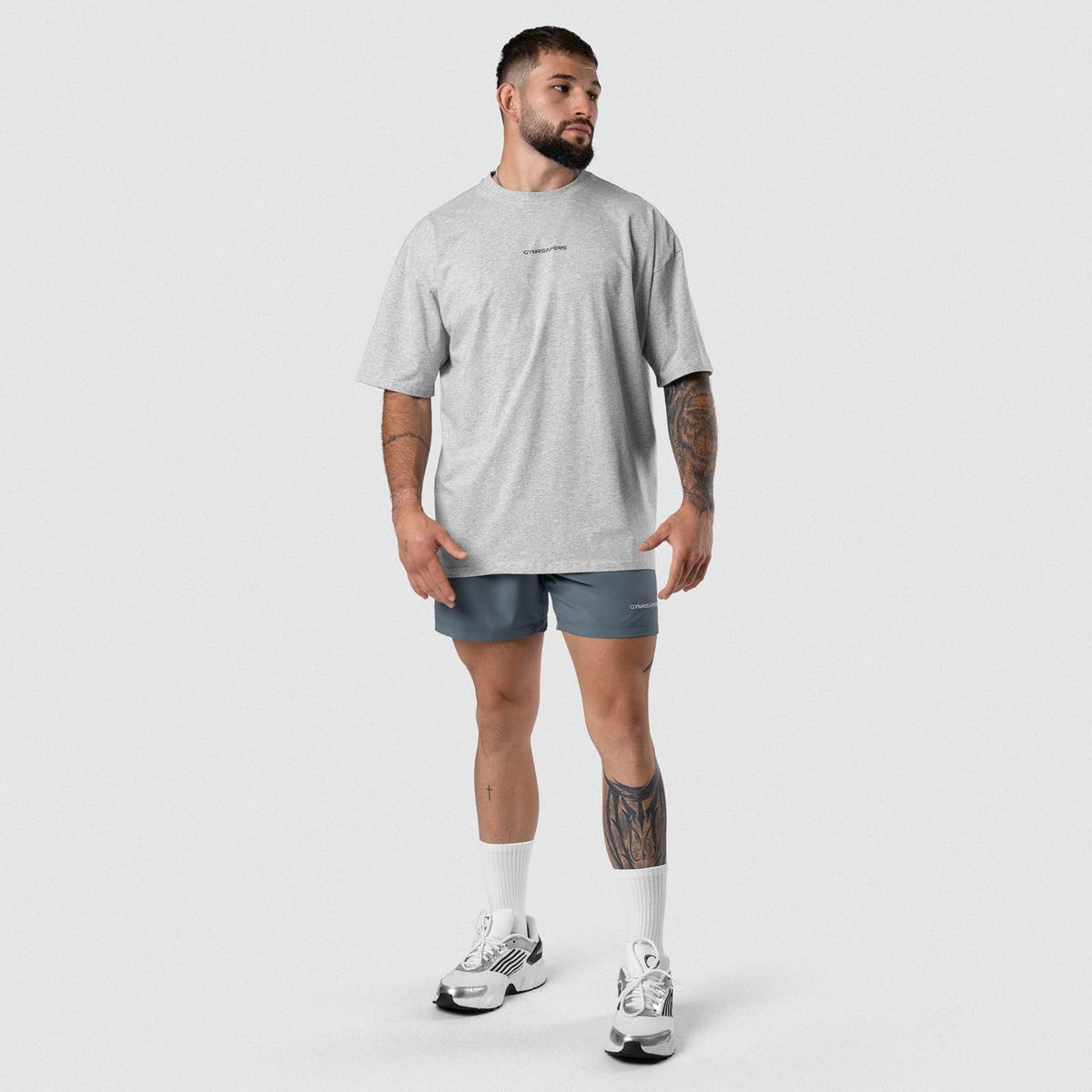 Male model wearing the Axis Box Tee - Heather Gray full-body view
