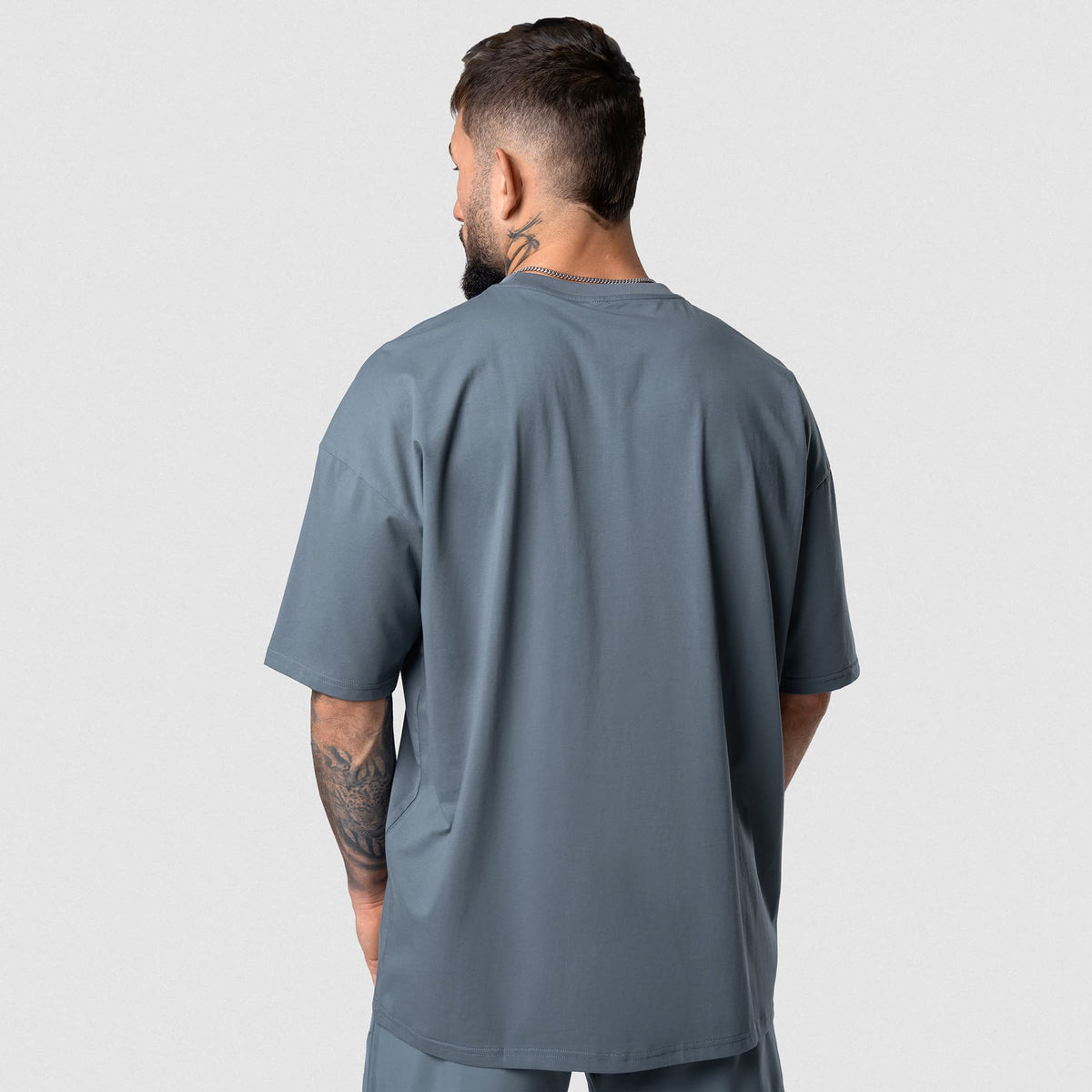 Male model wearing the Axis Box Tee - Lake back view