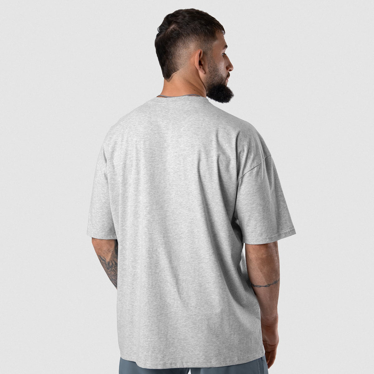 Male model wearing the Axis Raglan Tee - Heather Gray back view