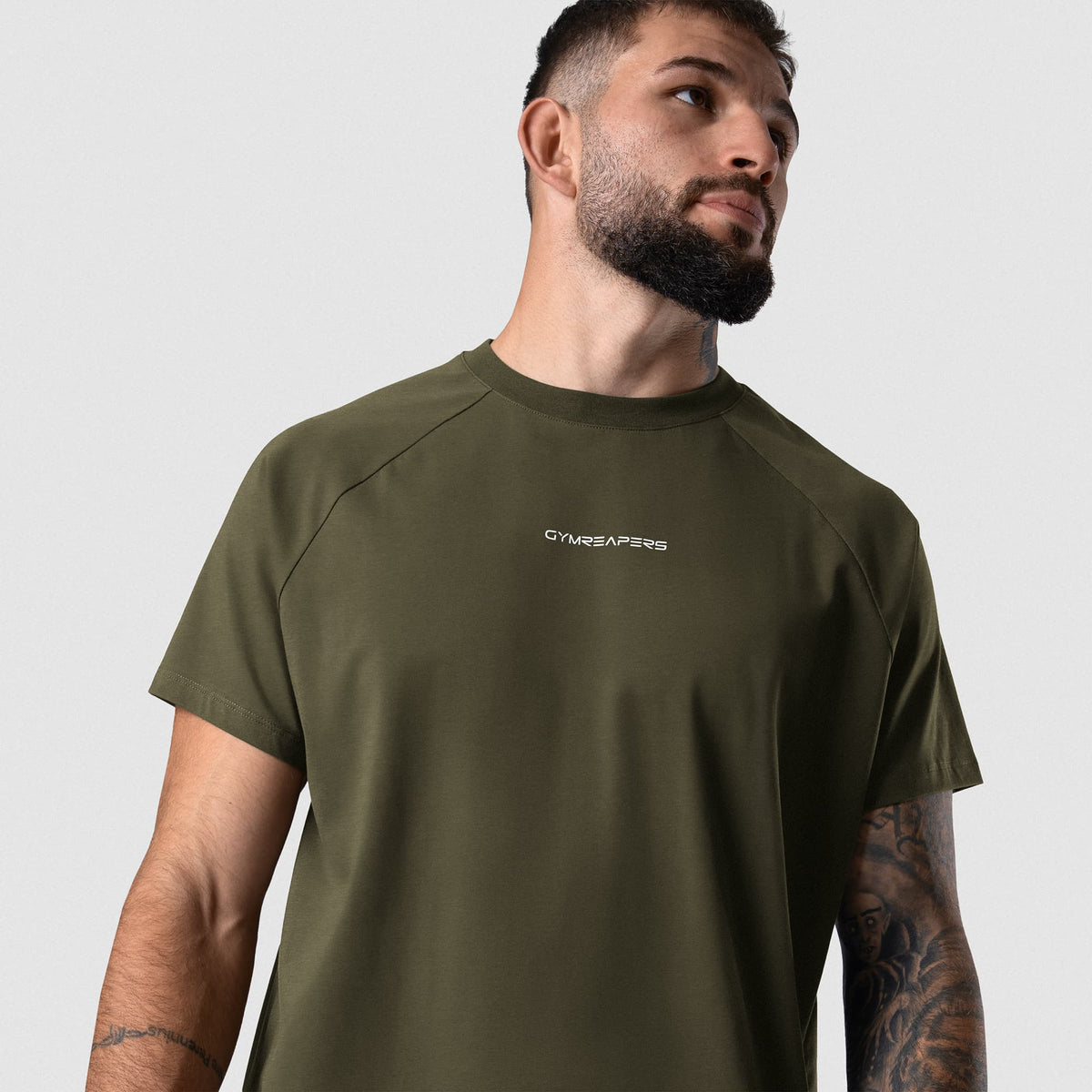Male model wearing the Axis Raglan Tee - OD Green angled front view