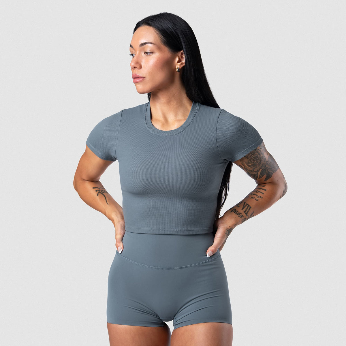 Female model wearing the Axis Support Baby Tee - Lake front view
