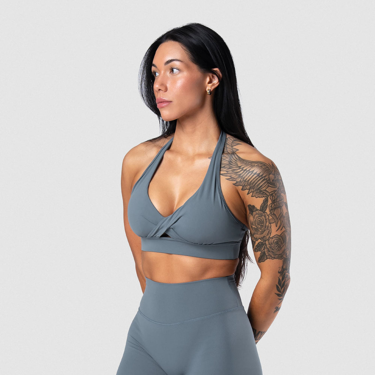 Female model wearing the Axis Twisted Halter Bra - Lake front view
