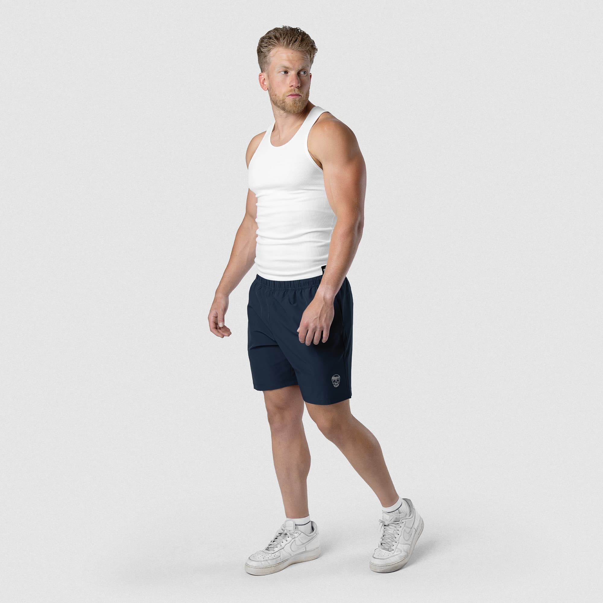 Model wearing Men's Conquer 7 Inch Shorts - Navy