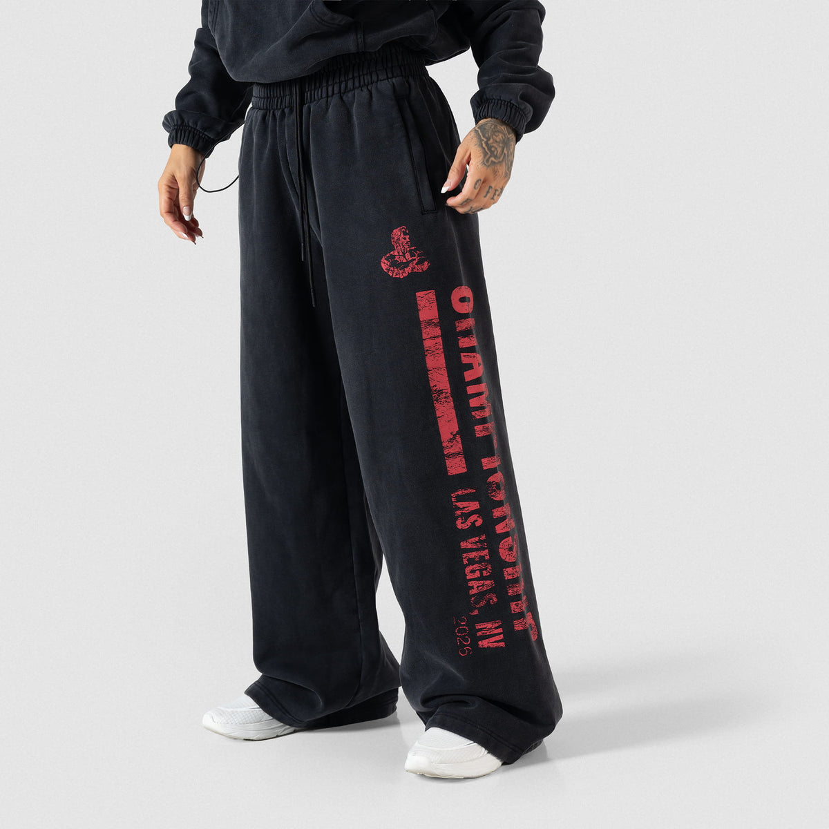 Front angled view of the Championship Wide-Leg Jogger in black that showcases the large red logo down the pant leg