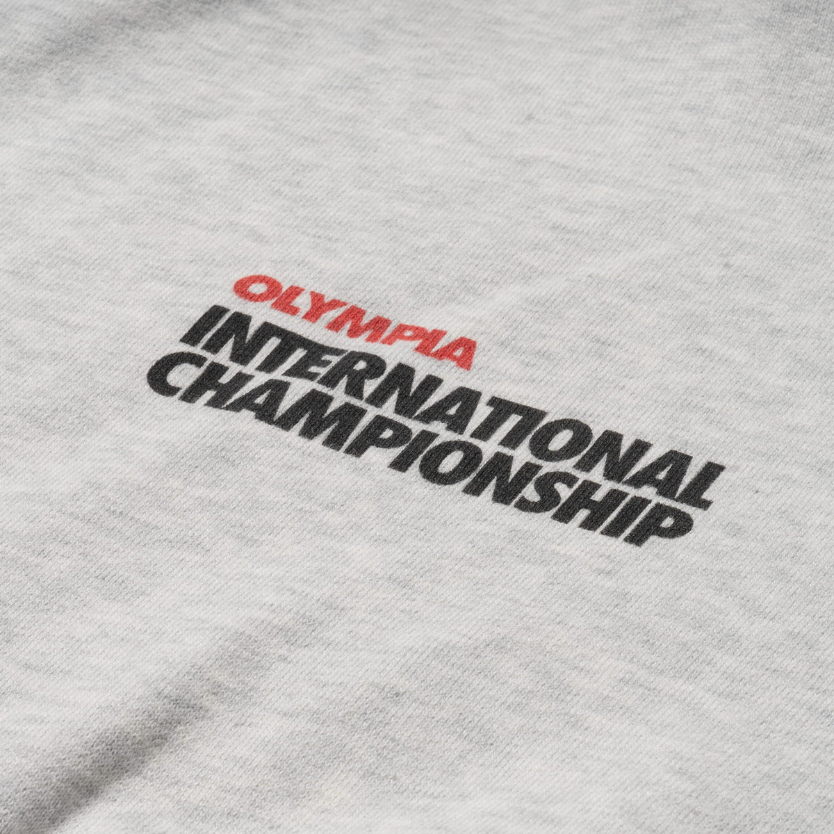 International Division Crop Hoodie | Close up of front logo that says "Olympia International Championship"