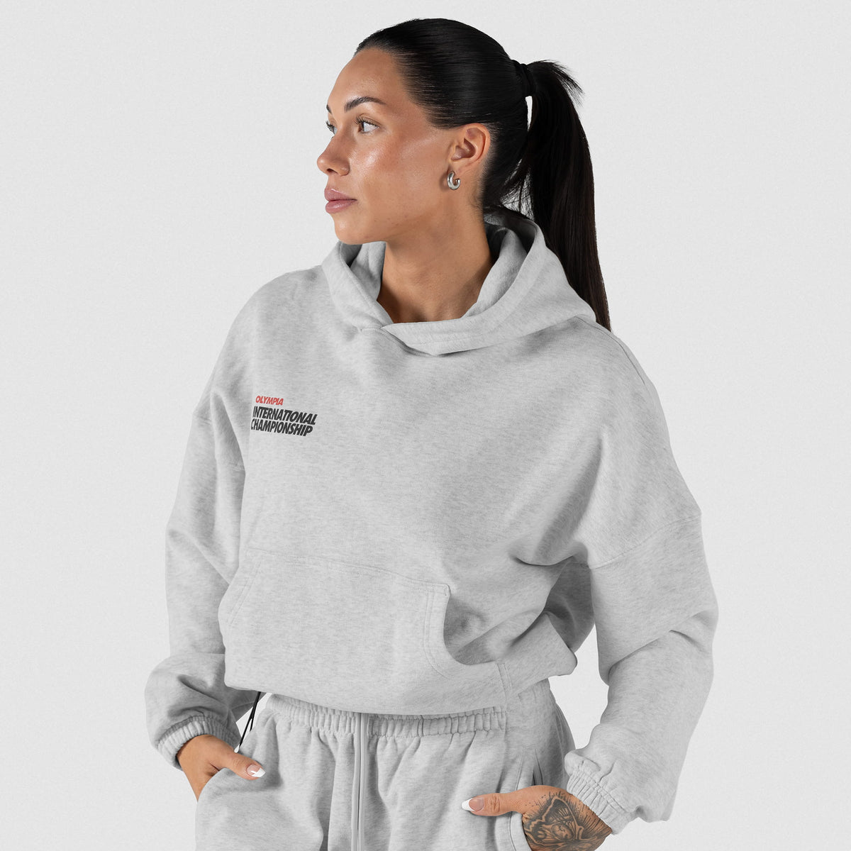 International Division Crop Hoodie | Model front view of the gray pullover hoodie