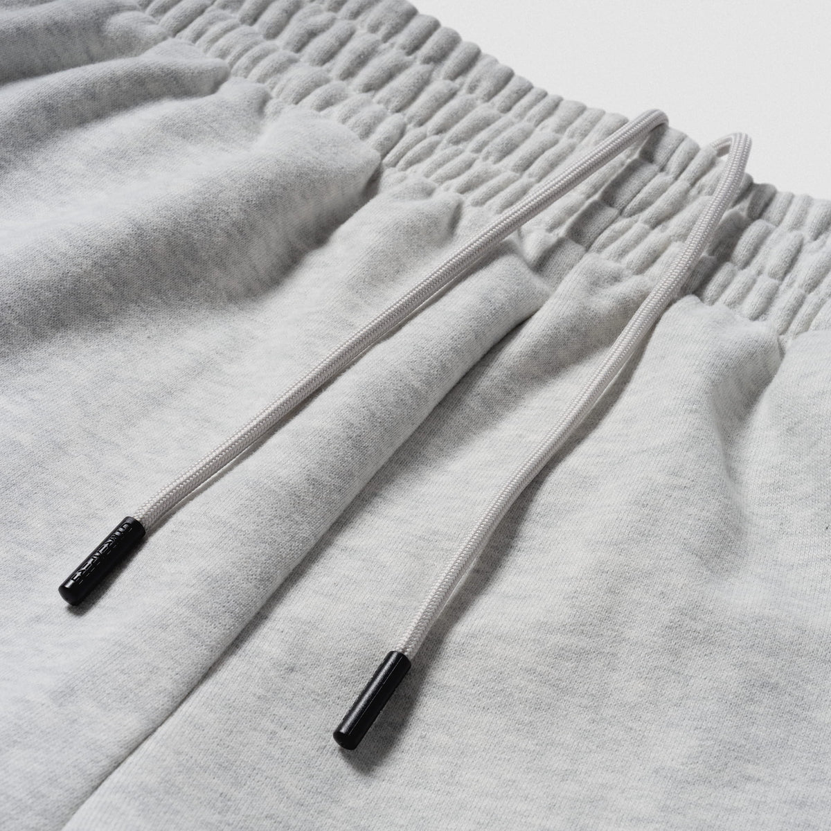 Close up of drawstrings and adjustable waistband on the Olympia International Division Straight-Leg Jogger in gray
