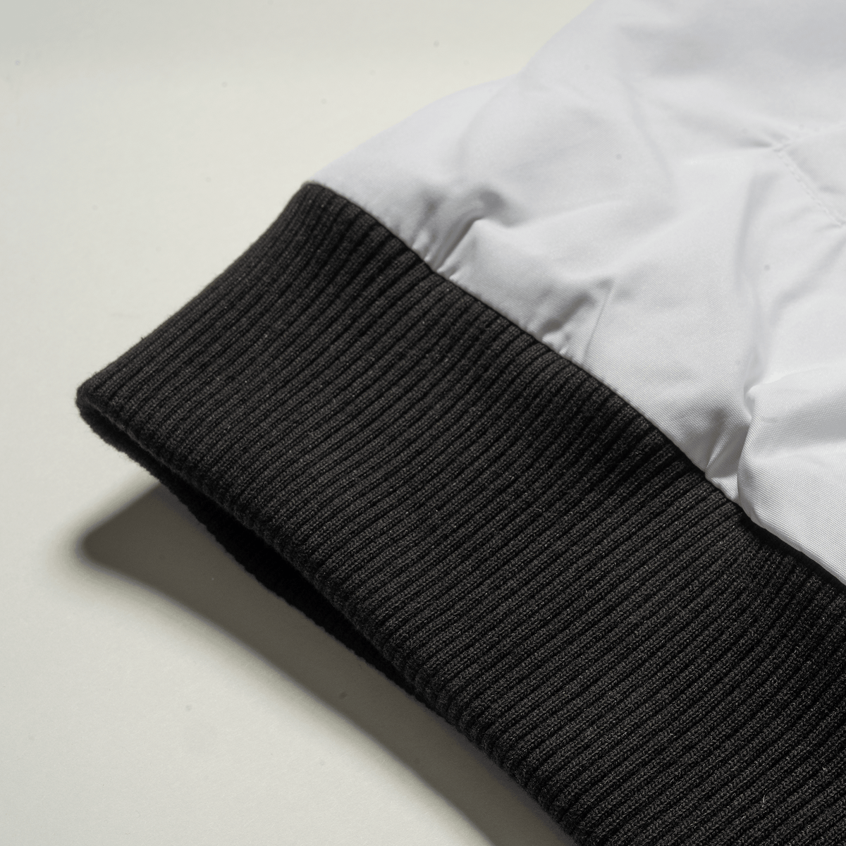 6. Olympia Signature Bomber Jacket in White – Black Ribbed Cuff Detail
